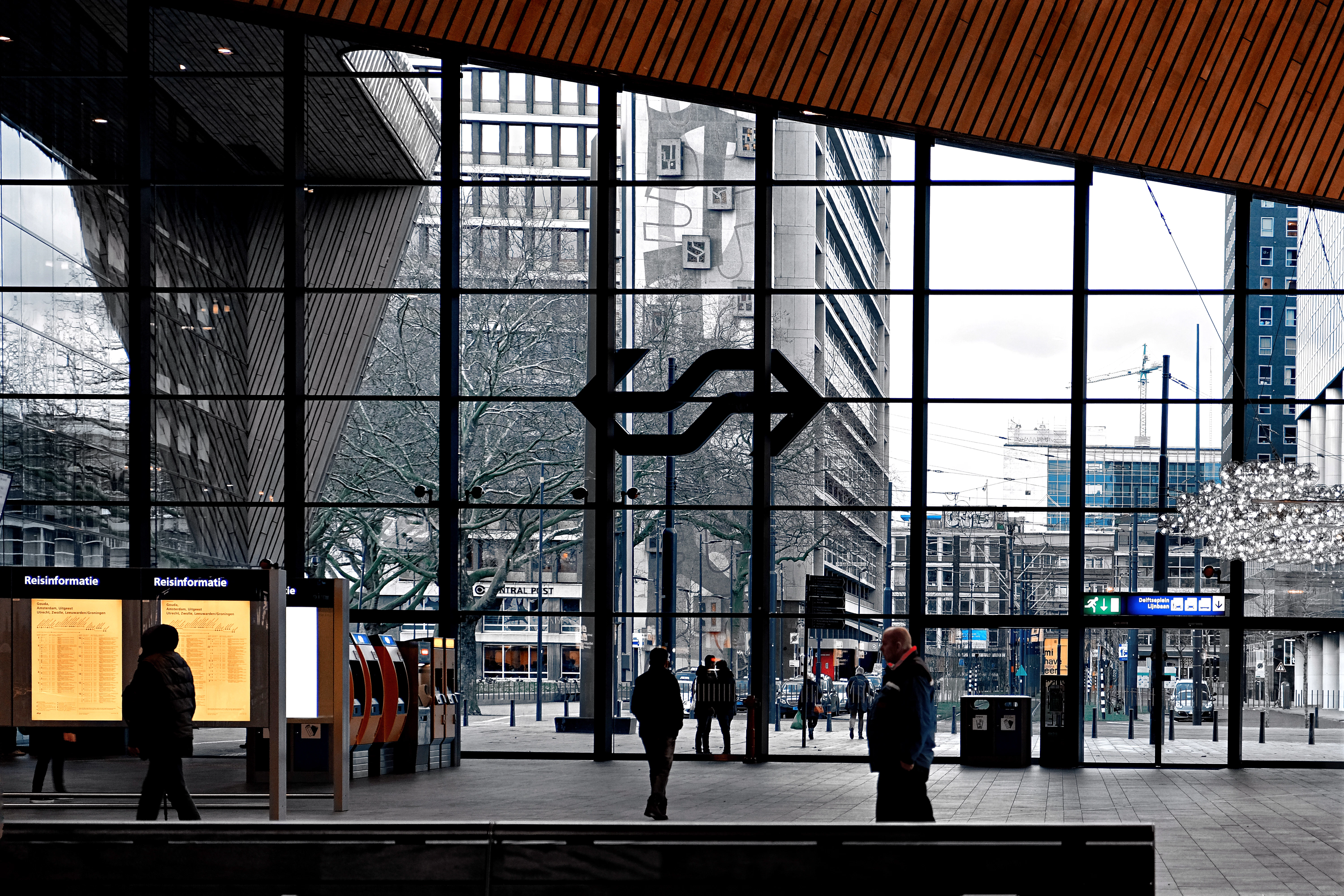 man in black jacket walking on sidewalk during daytime