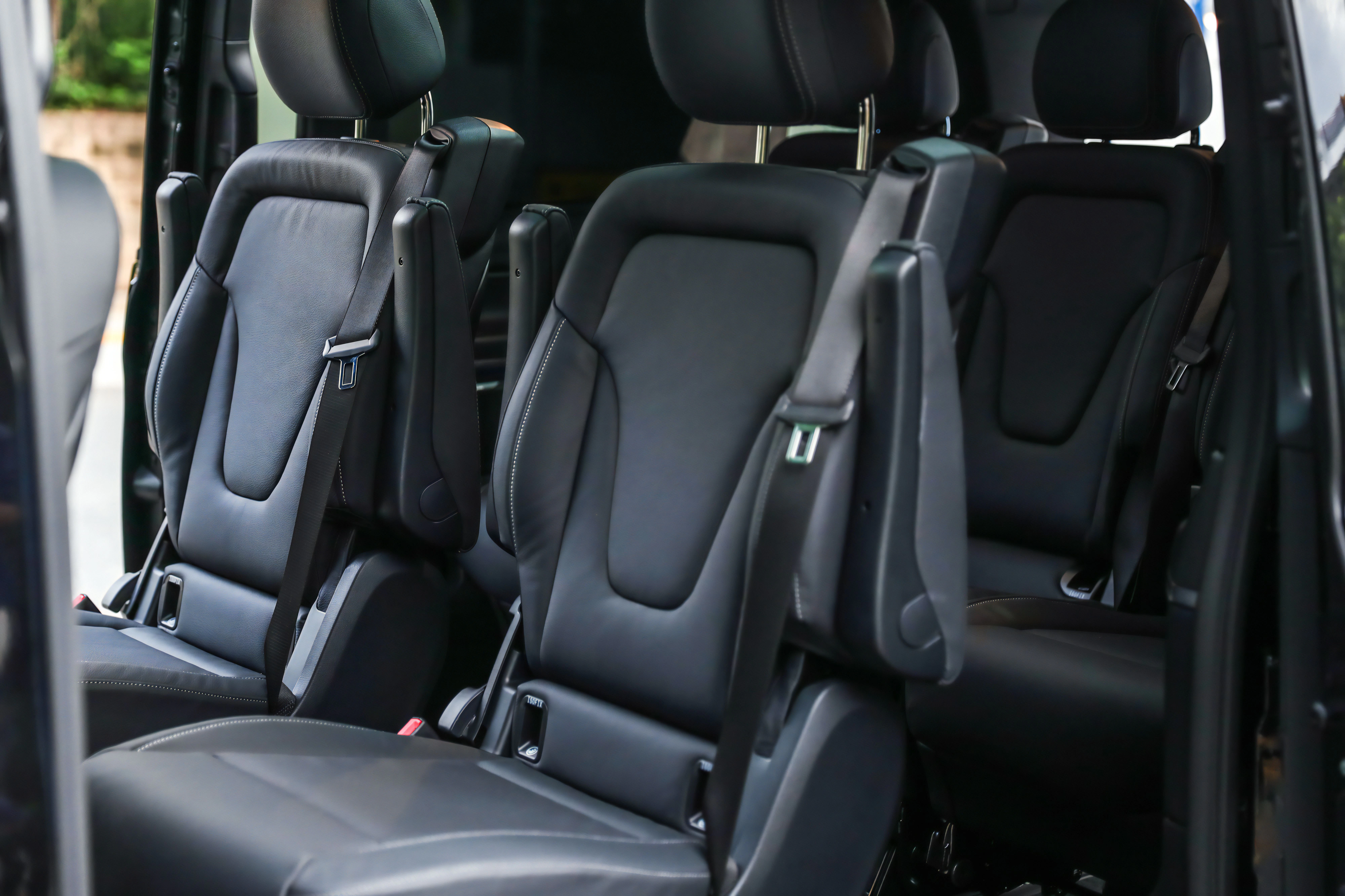 Luxurious black leather seats in a van.