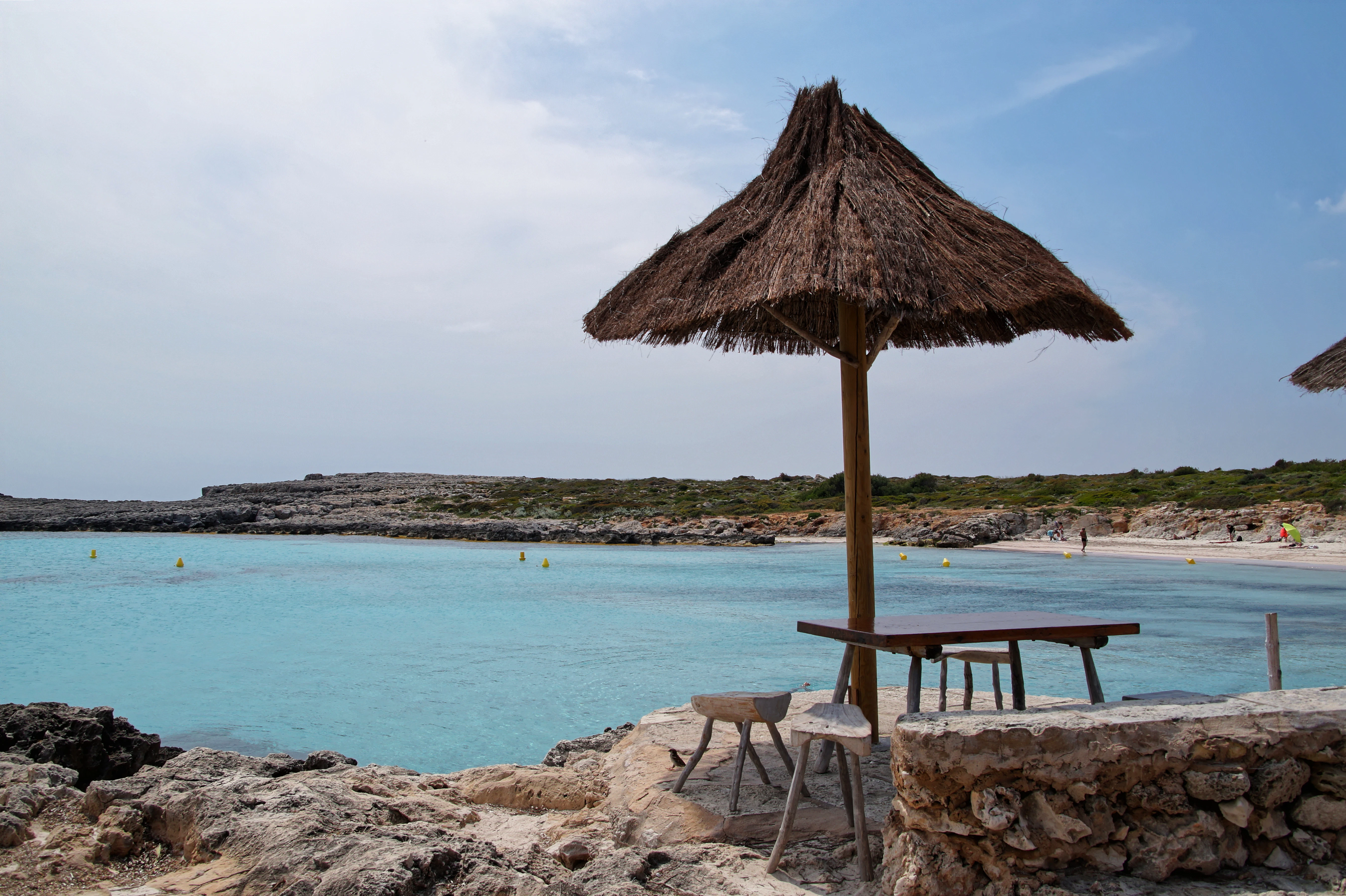 brown wooden beach lounge chair on beach shore during daytime