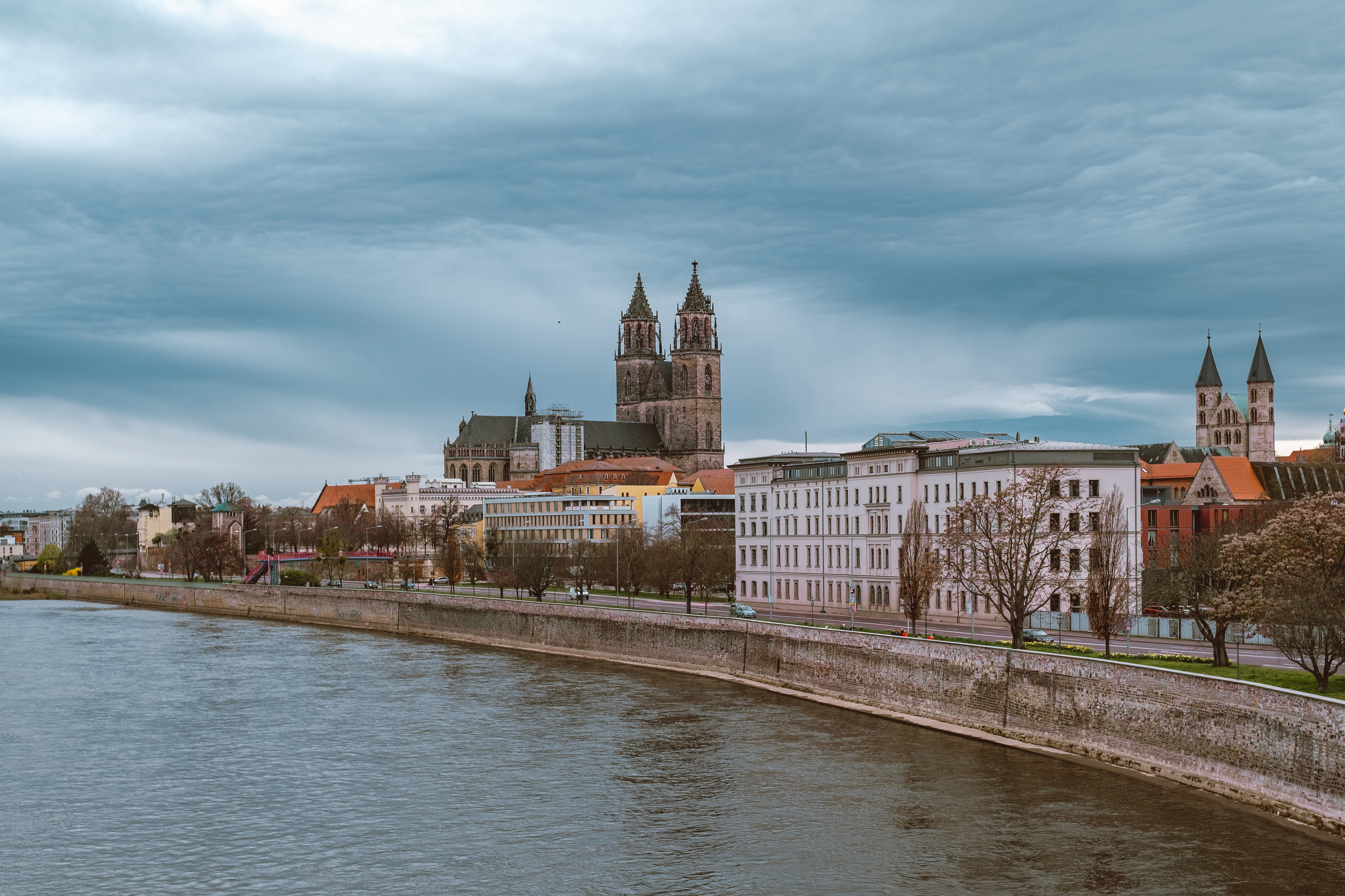 A river running through a city next to tall buildings