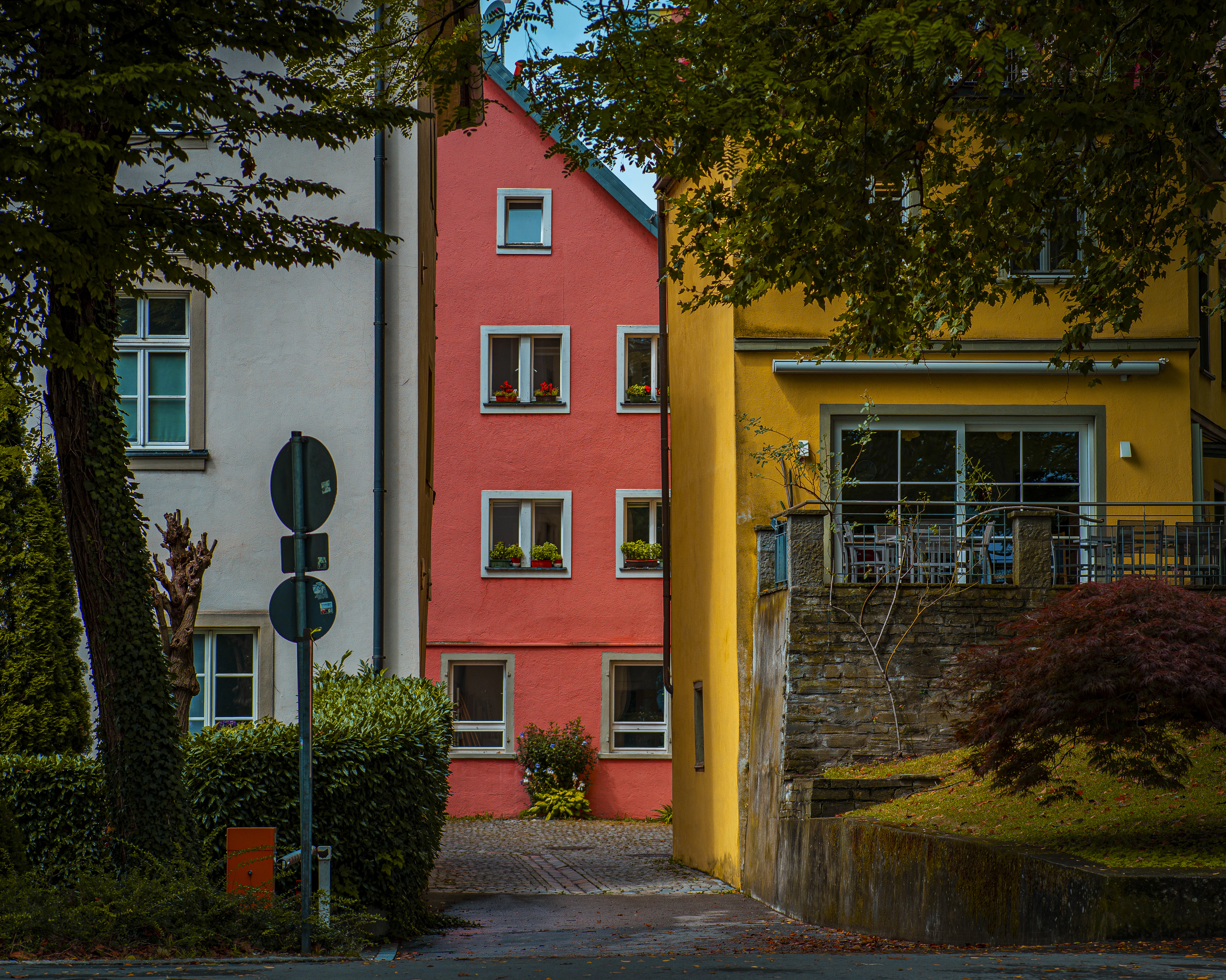 A red and yellow house sitting on the side of a road