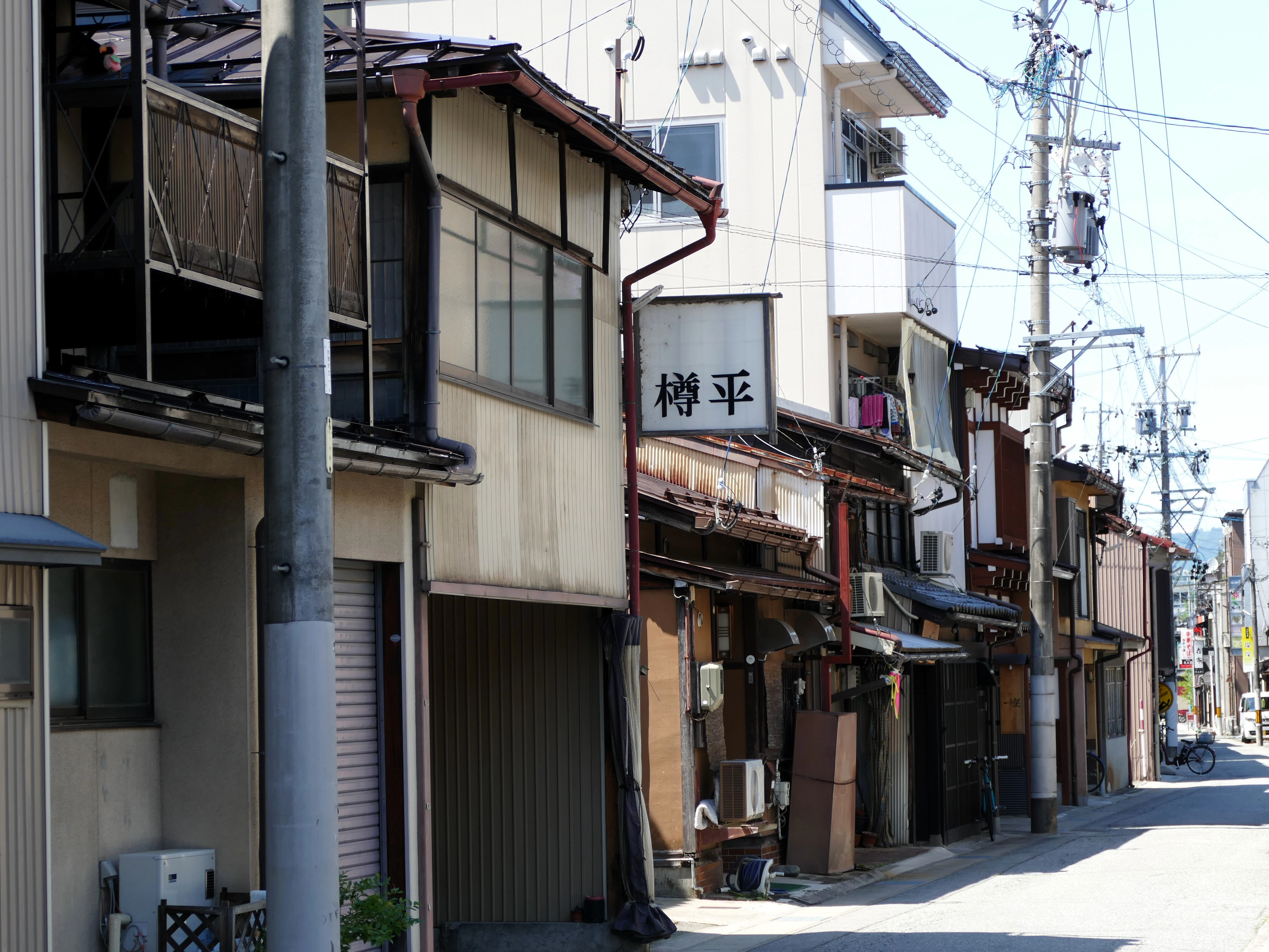 A city street lined with tall buildings next to each other
