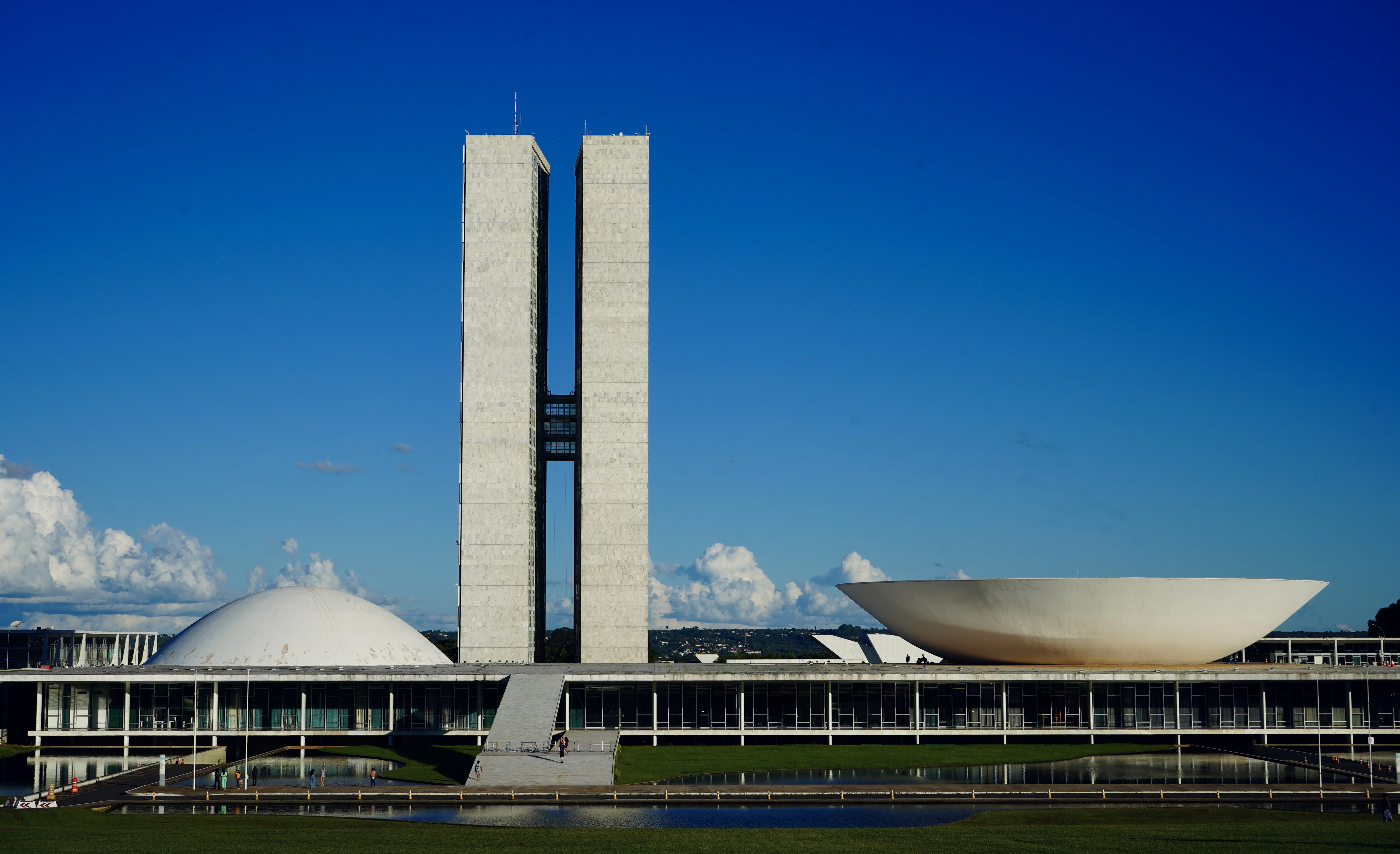 a large building with a tall tower next to a body of water