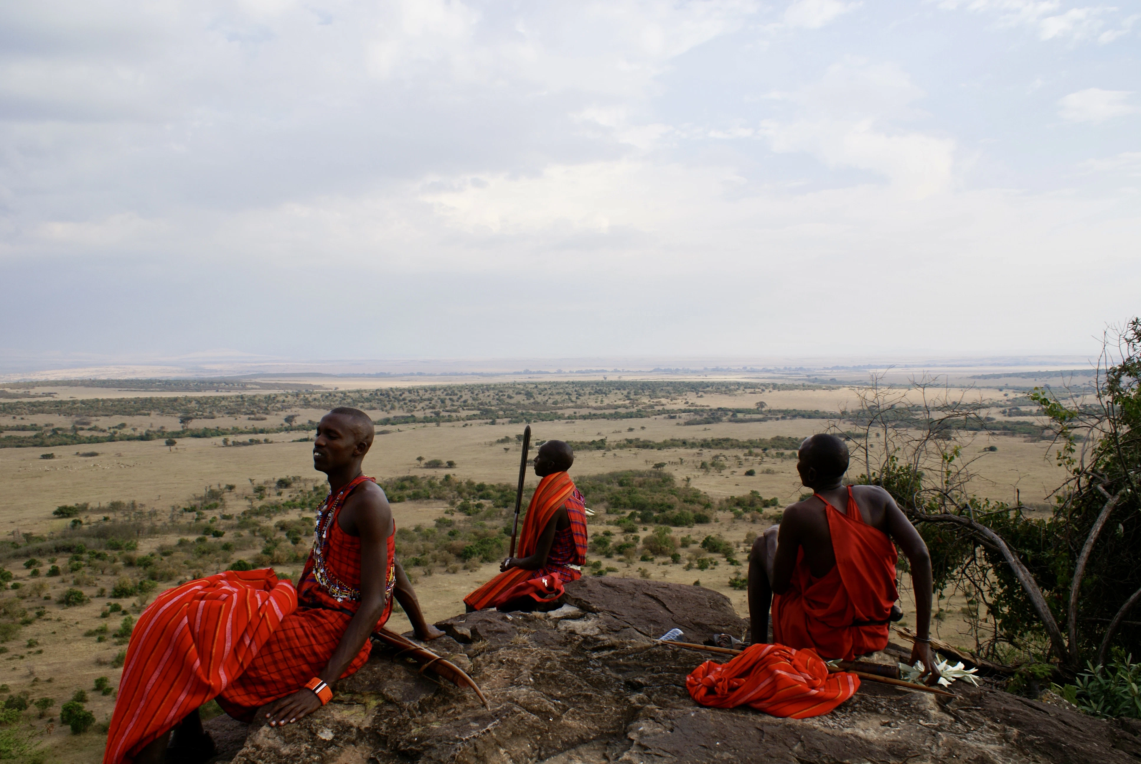 A group of people sitting on top of a rock