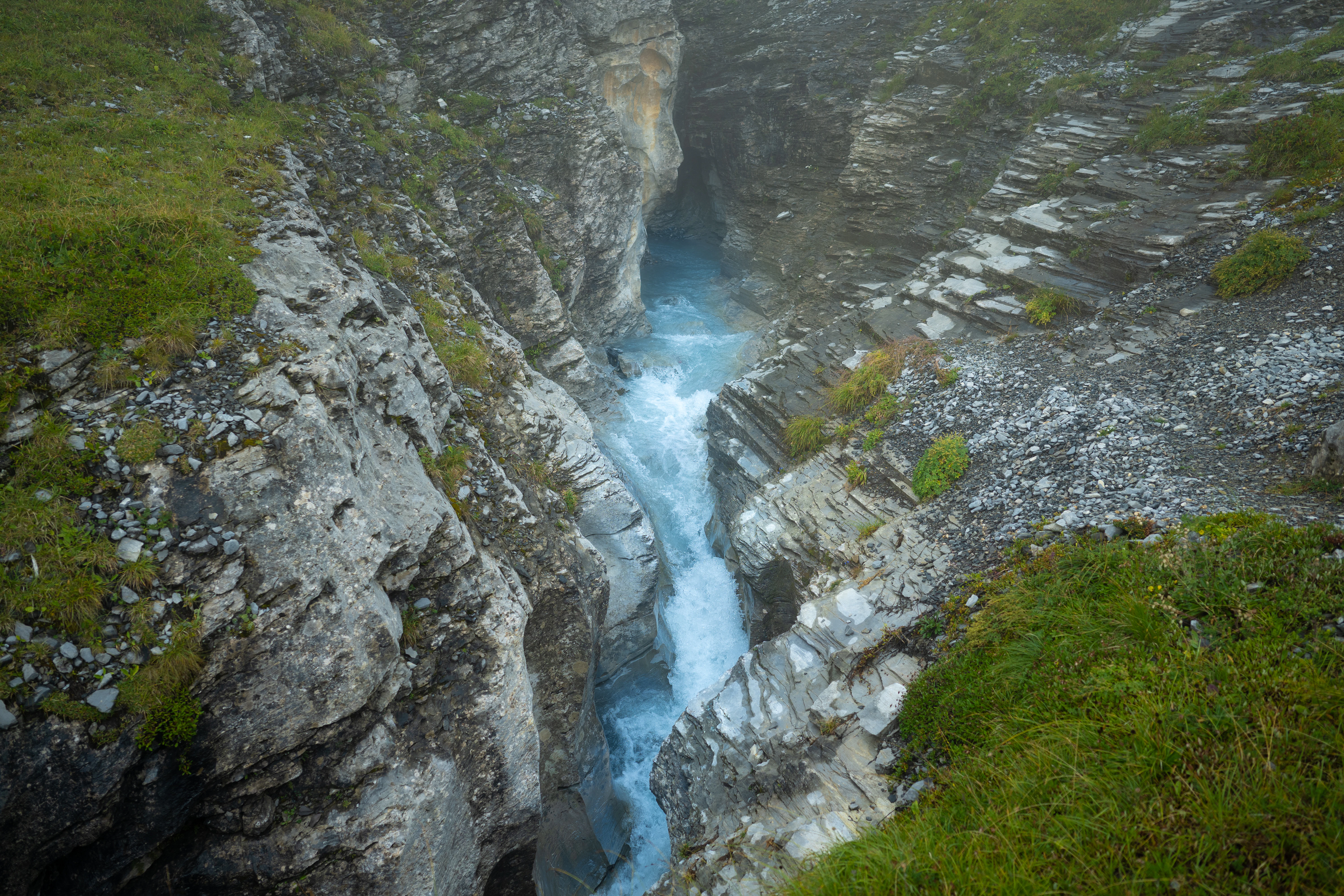 A fast-flowing river cuts through a rocky gorge.
