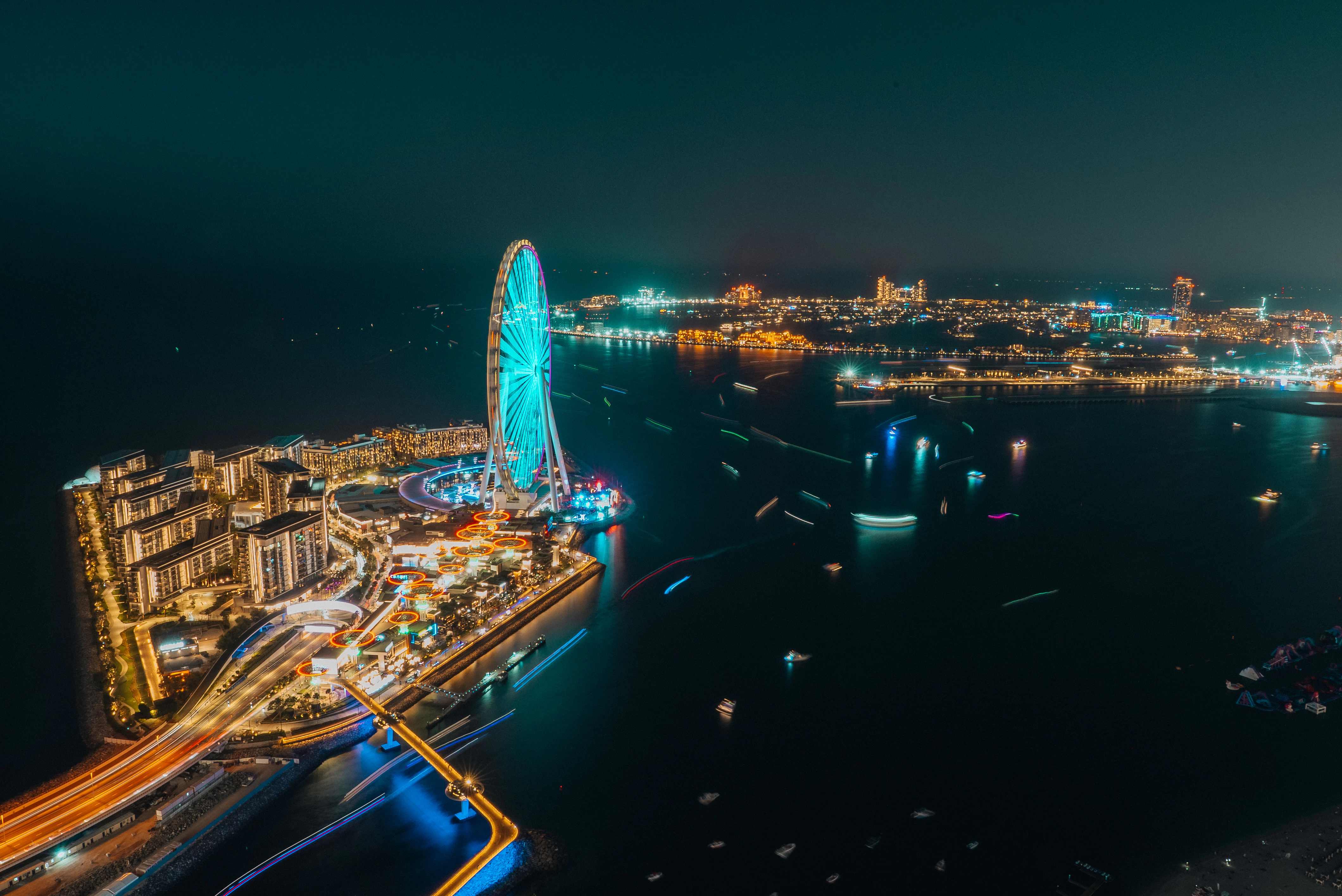 Nighttime aerial view of a lit cityscape.