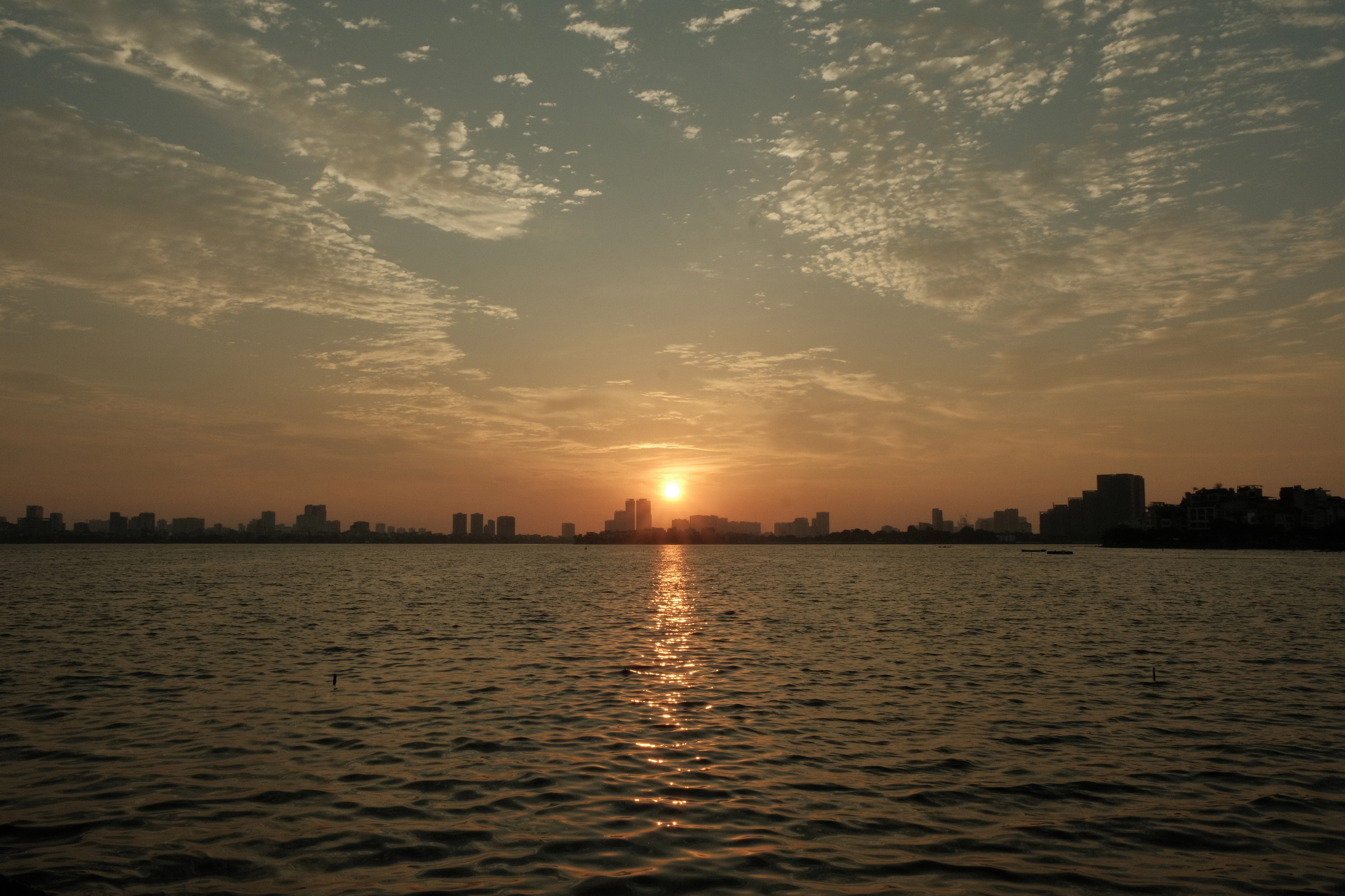 the sun is setting over a body of water