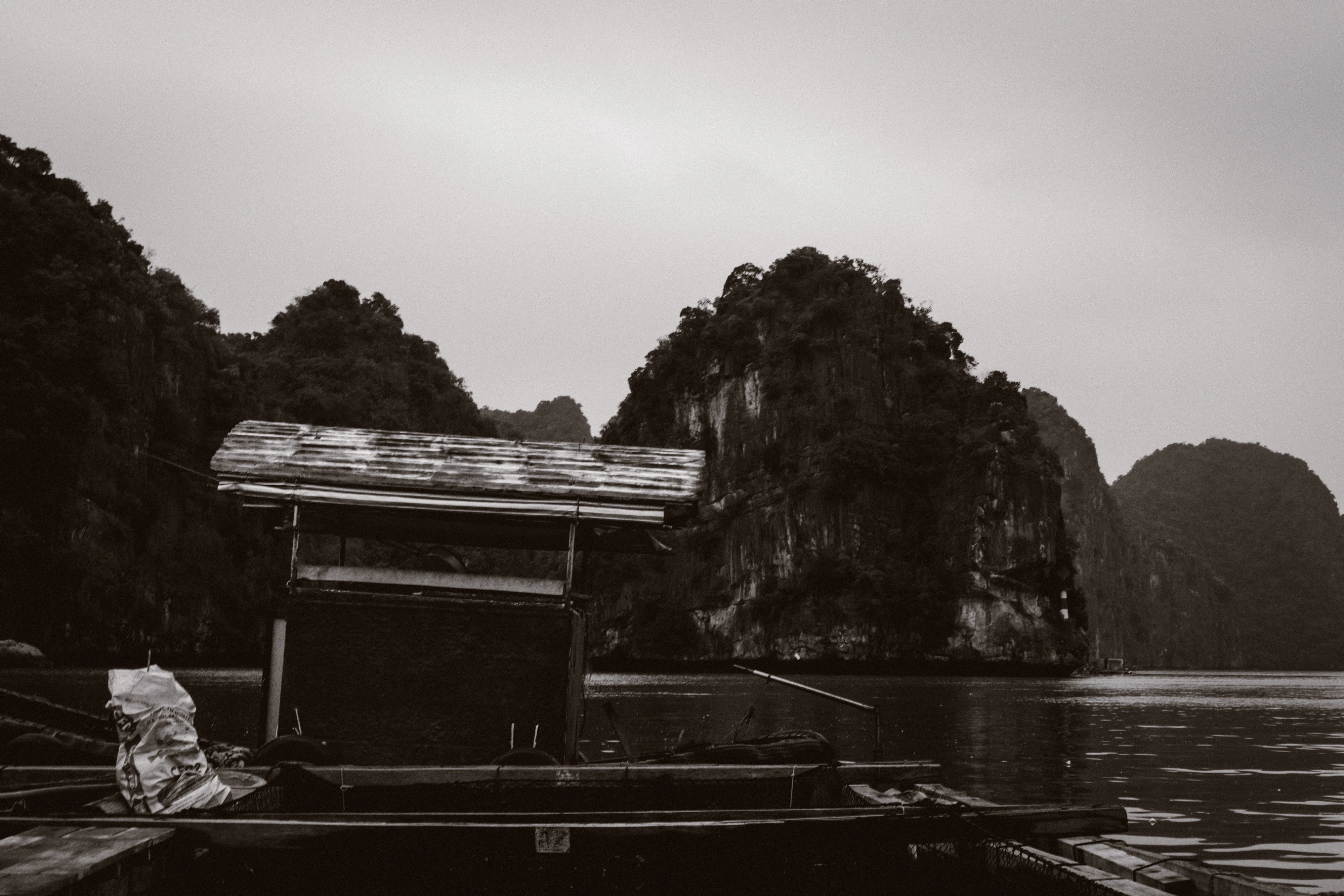 A black and white photo of a boat in a body of water