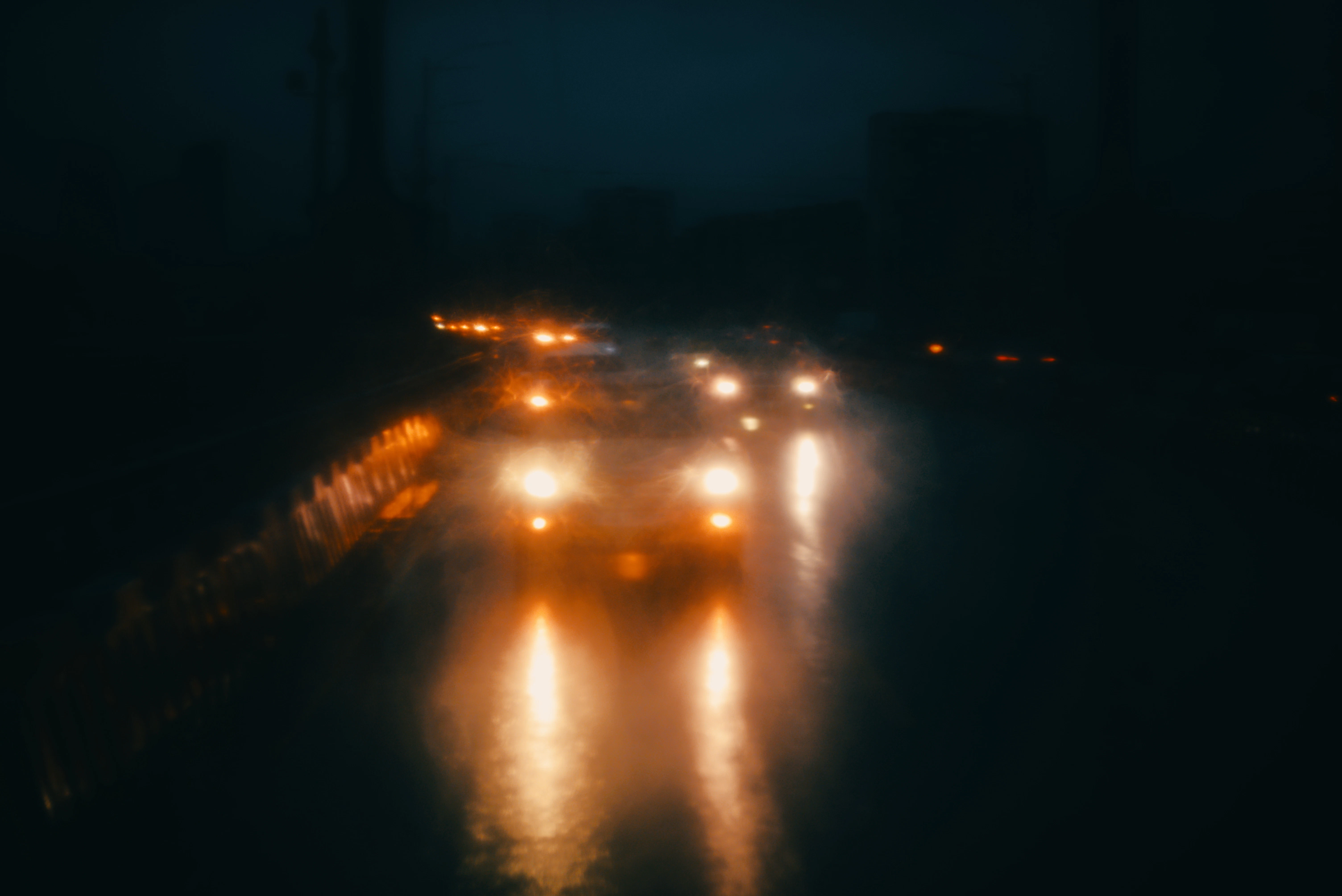 a street filled with lots of traffic at night