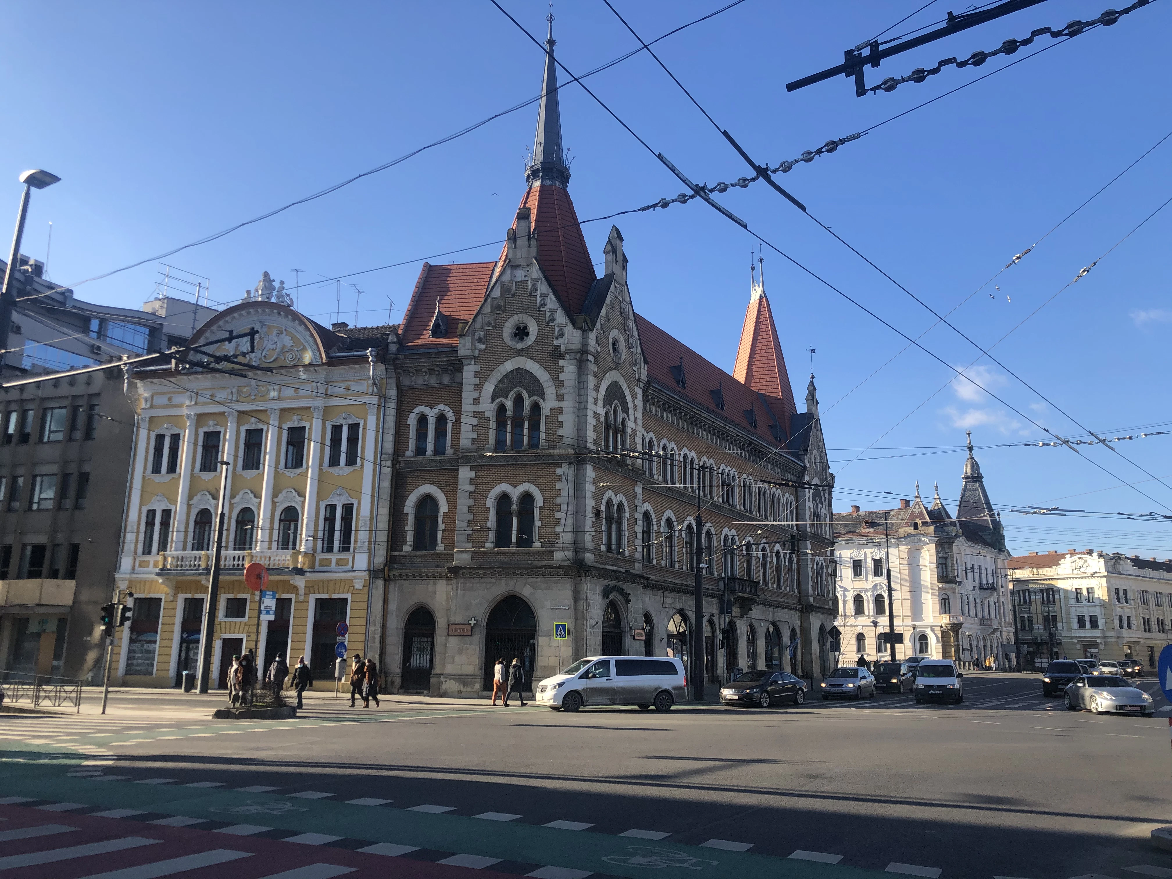 cars parked in front of brown concrete building during daytime