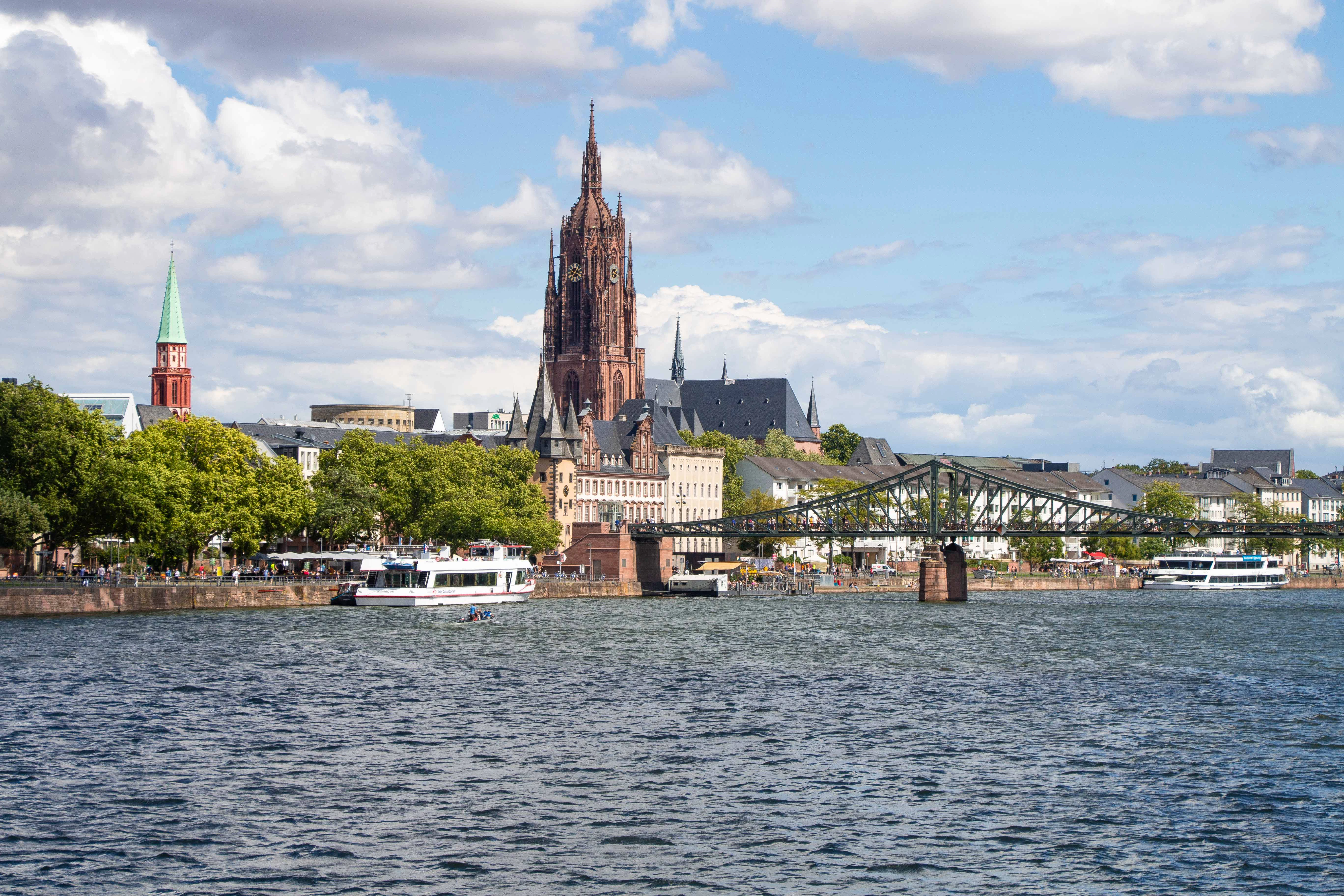 a large cathedral towering over a city next to a river