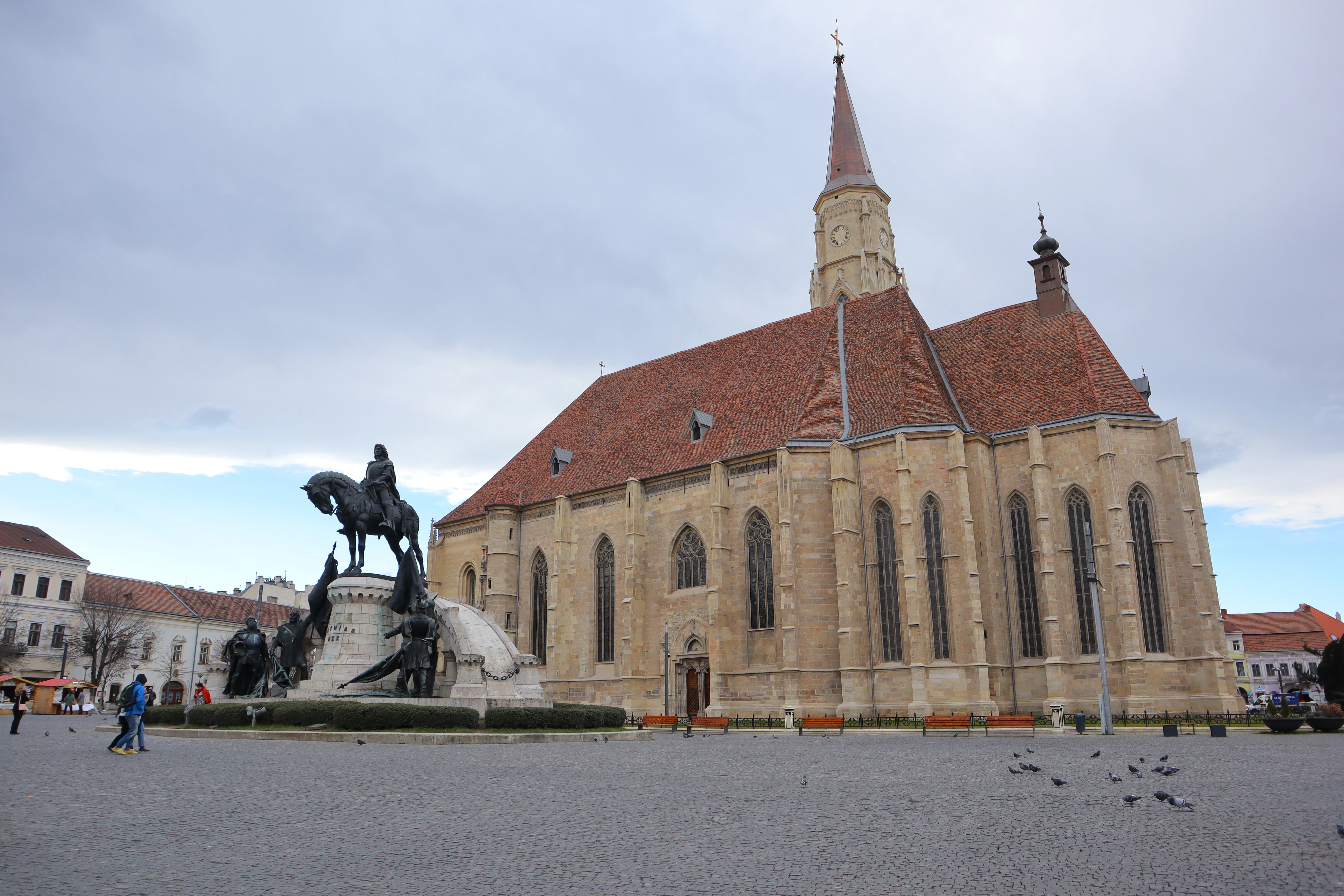 a statue of a man on a horse in front of a church