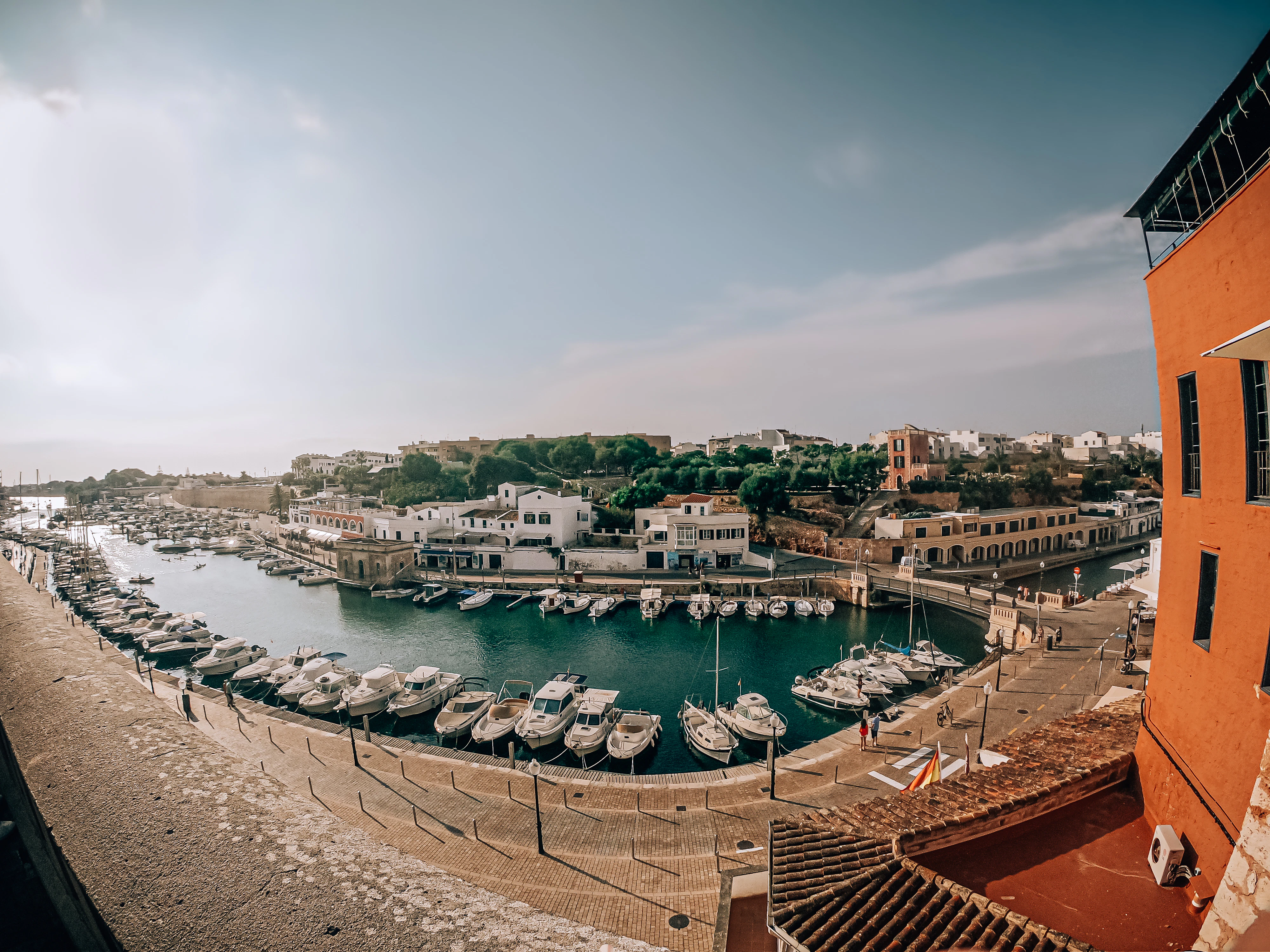 brown and white concrete building near body of water during daytime
