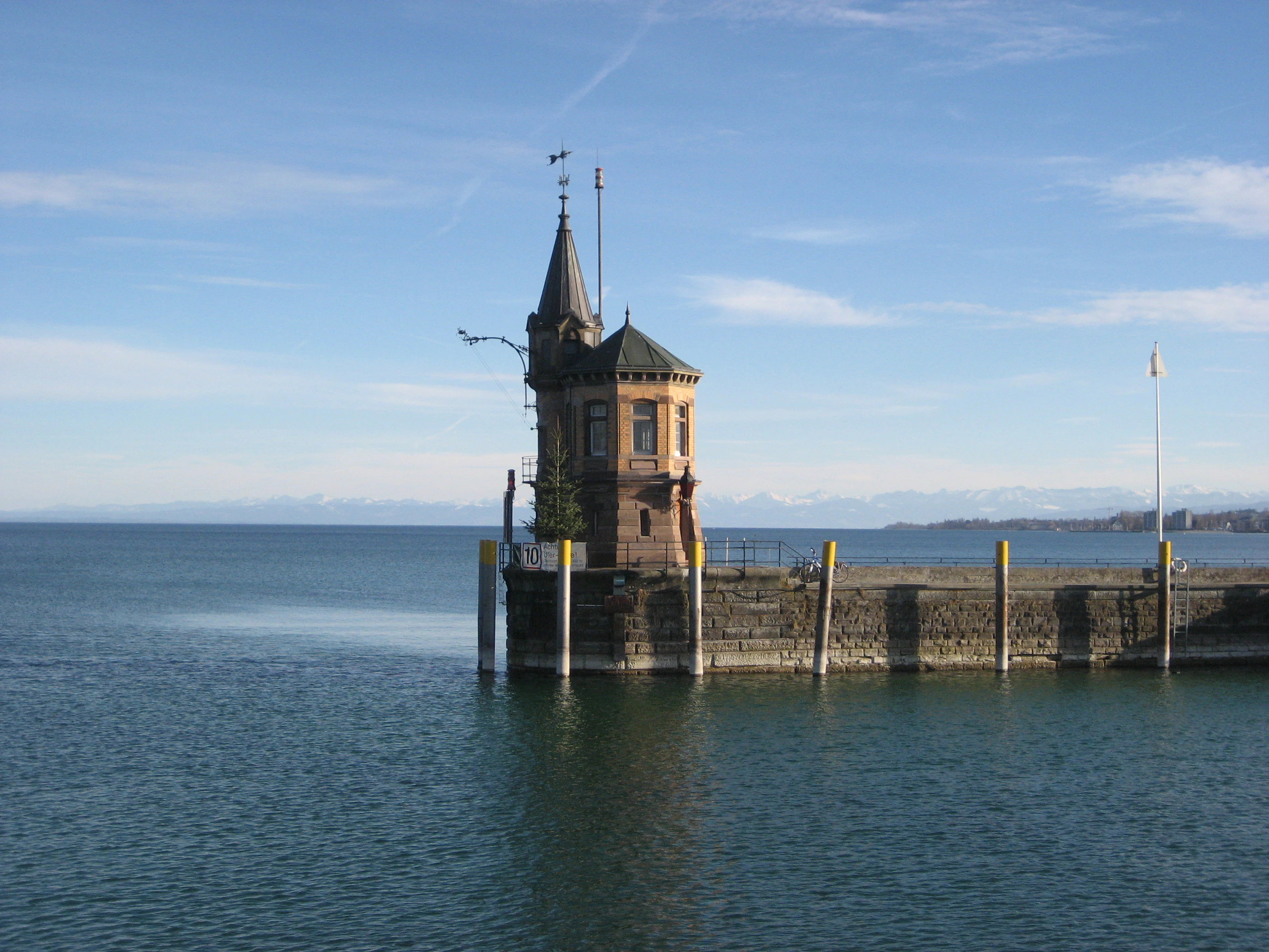 a clock tower sitting in the middle of a body of water