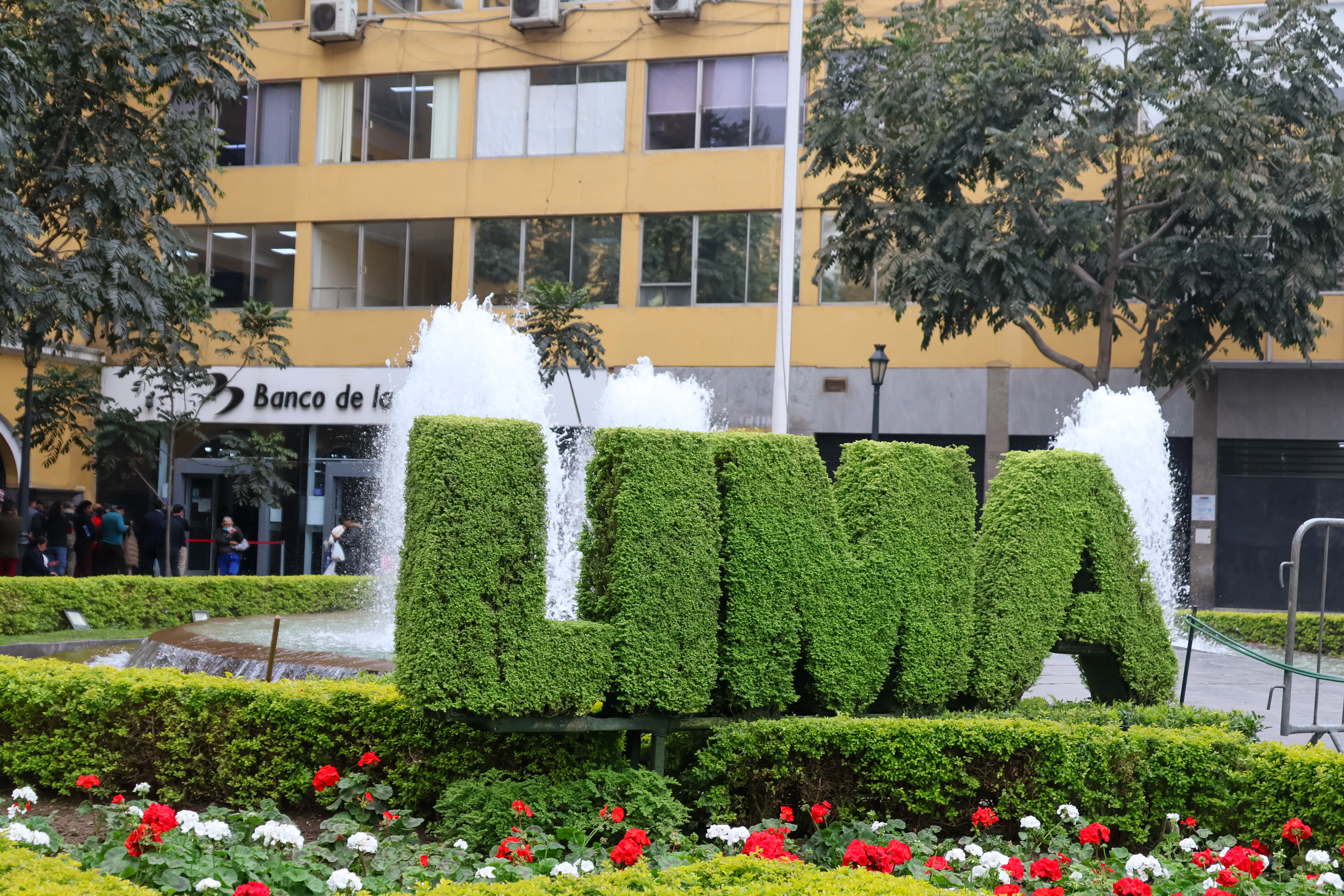 A large sign that is in the middle of a garden