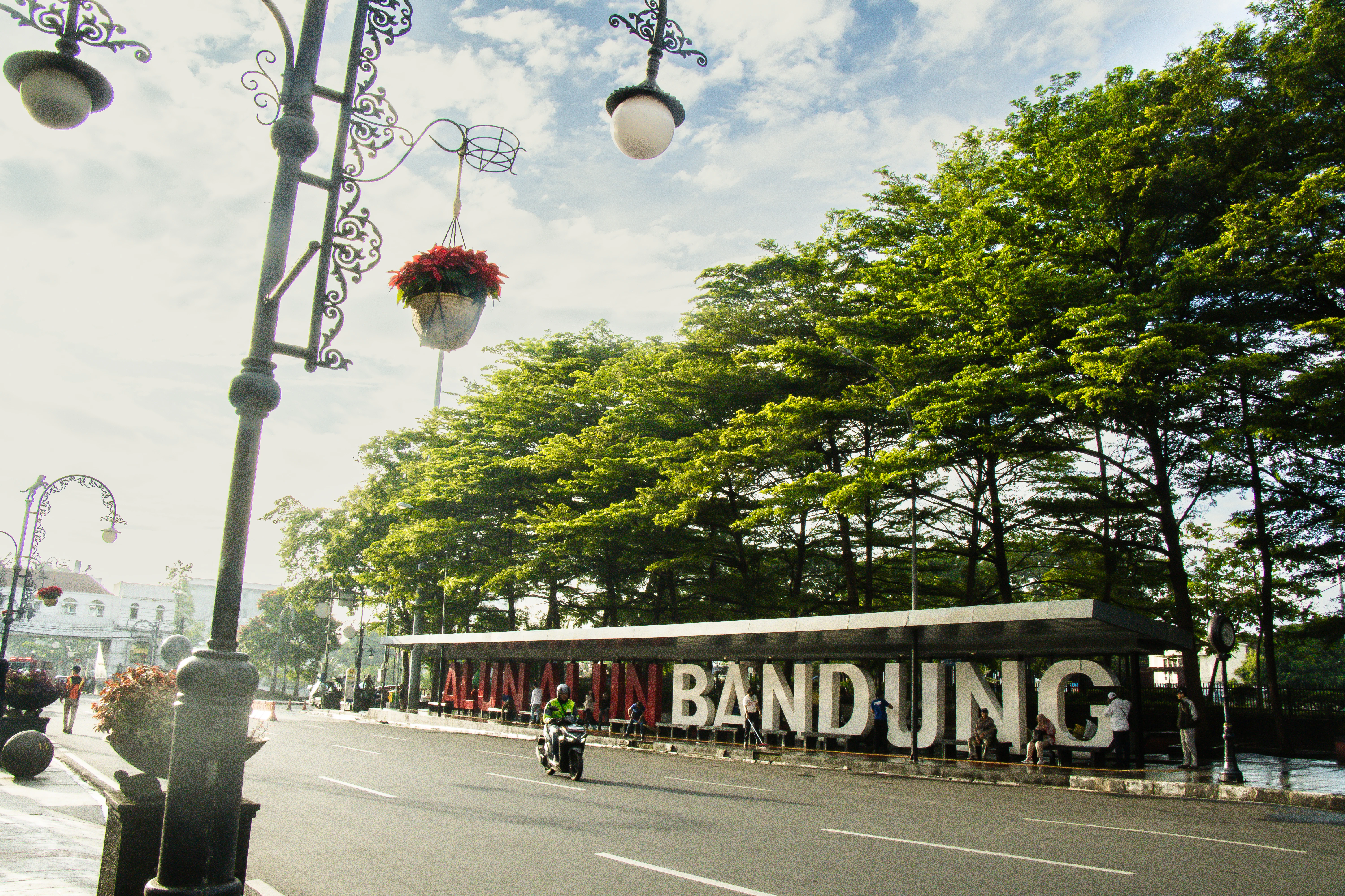 Bandung city sign with trees and decorative lamps.