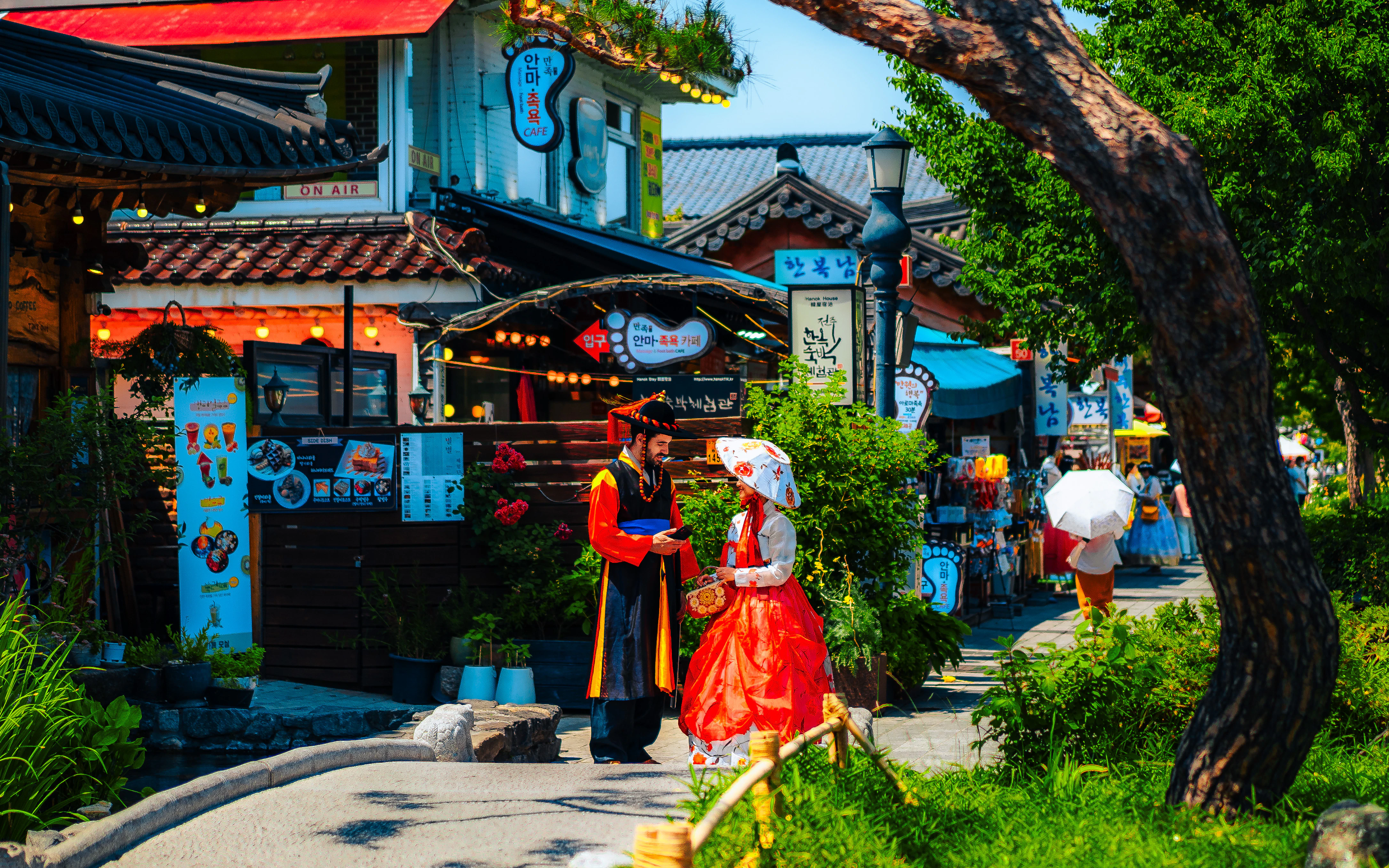 A woman in a red dress walking down a street
