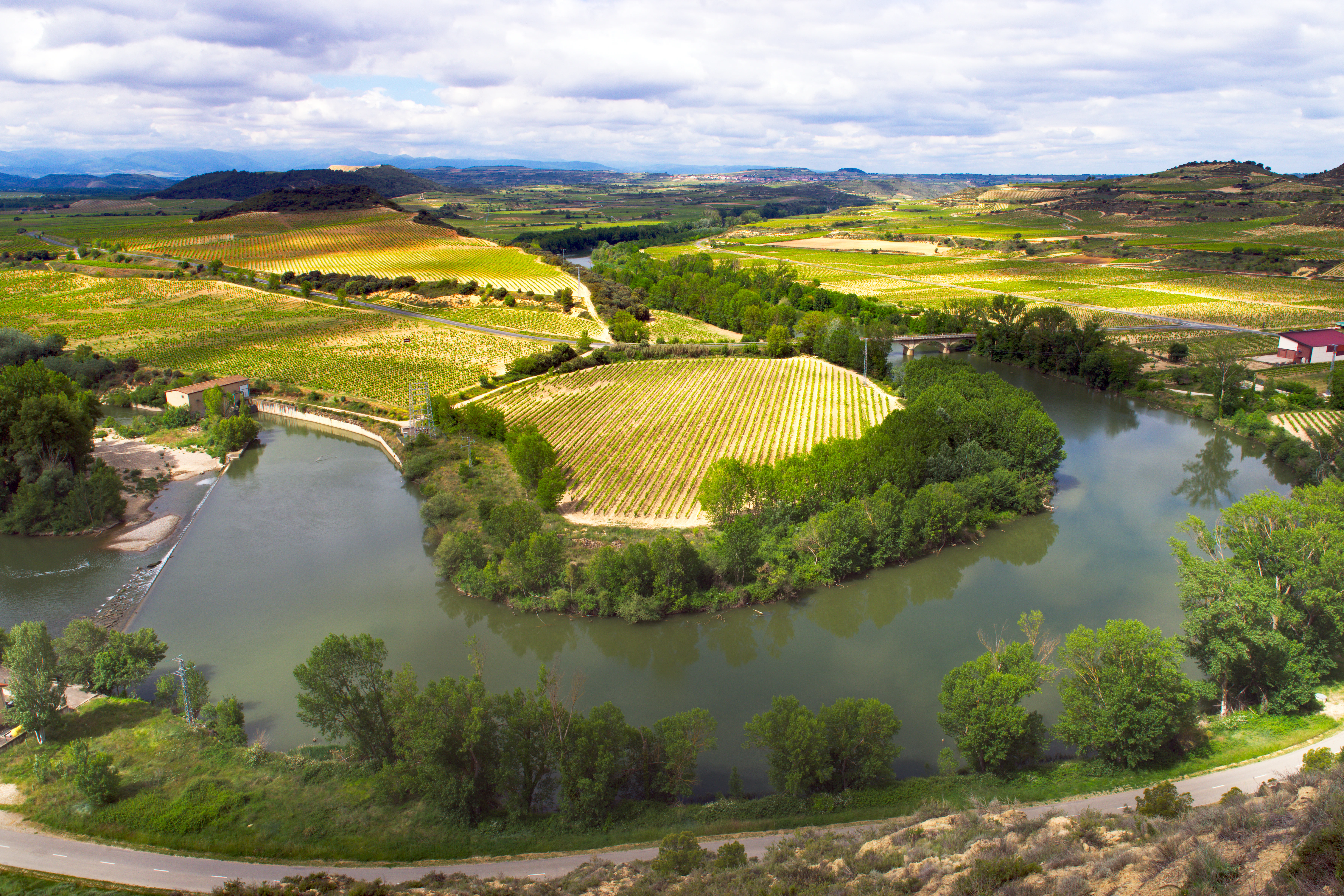 A river running through a lush green countryside