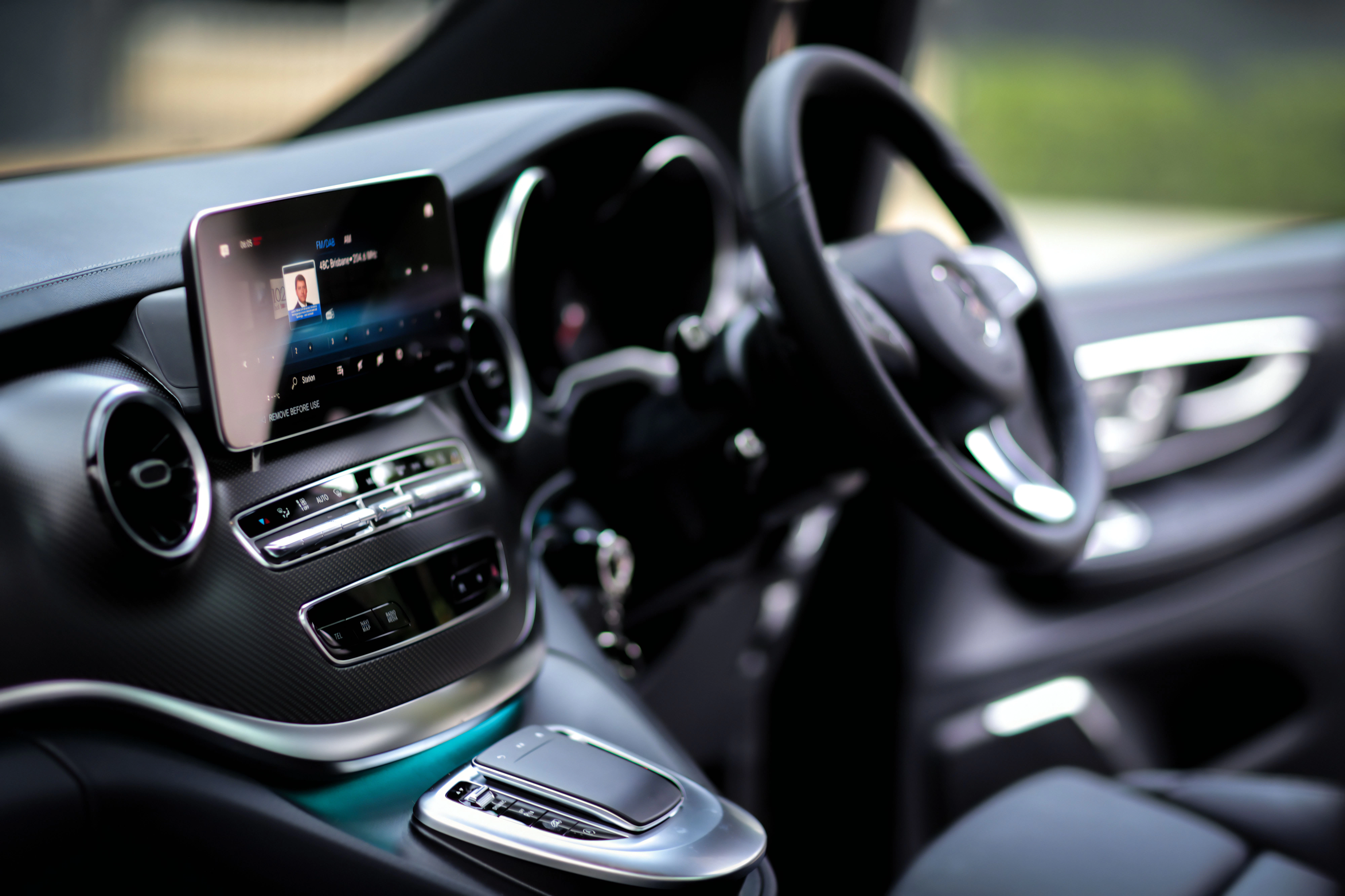 Interior view of a car's dashboard and steering wheel.