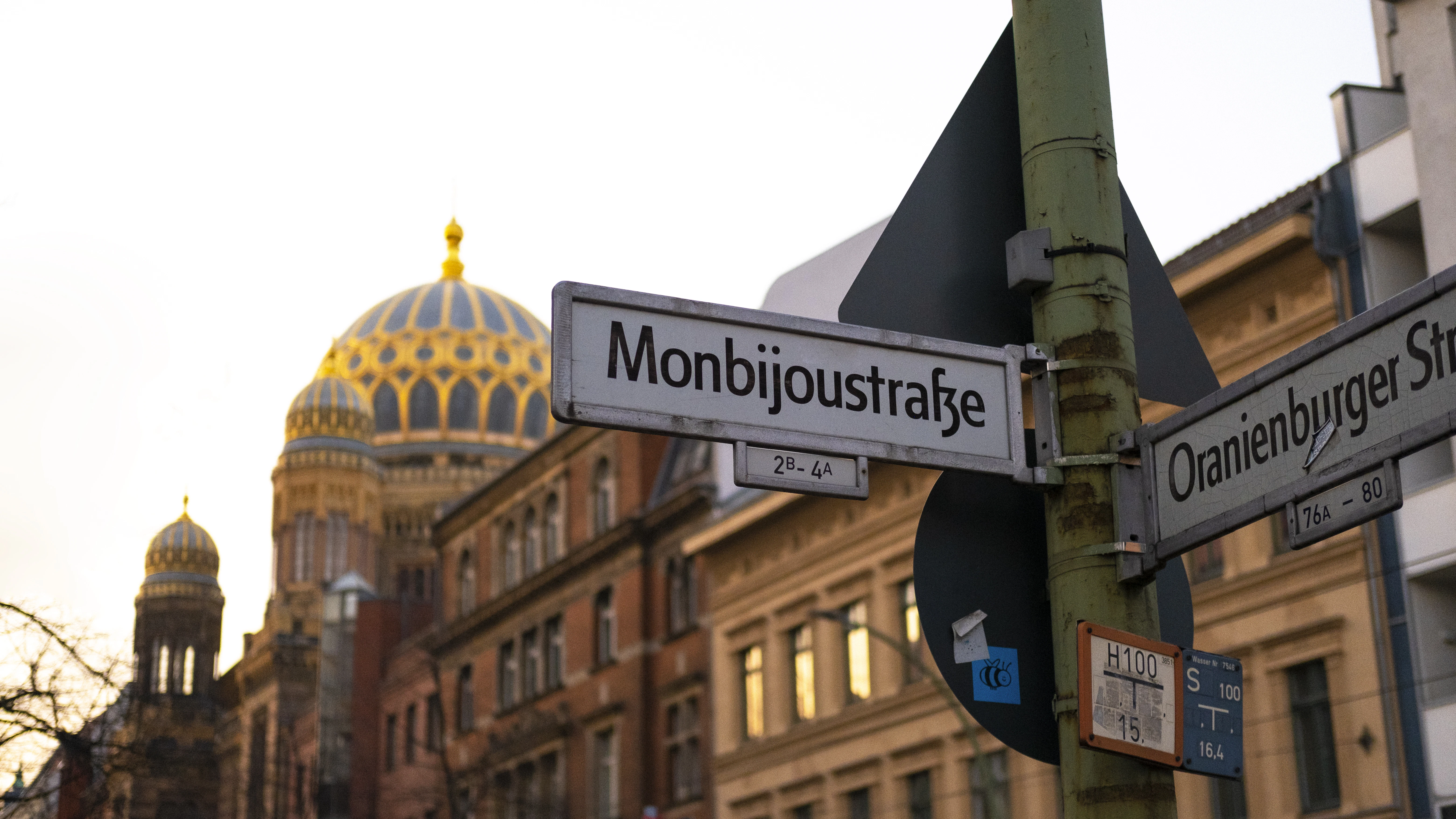 a street sign in front of a large building