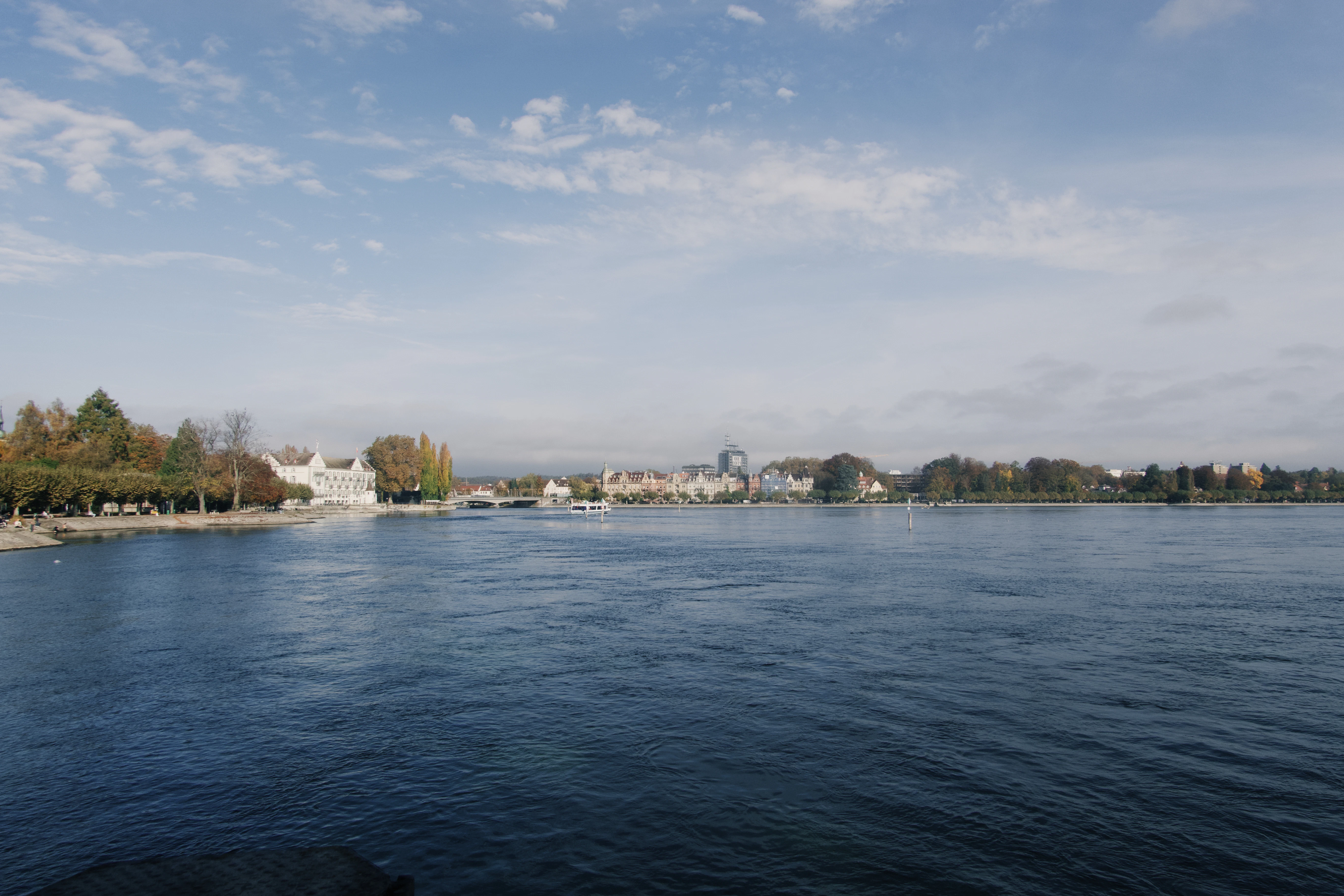 Waterfront view of a town under a blue sky.
