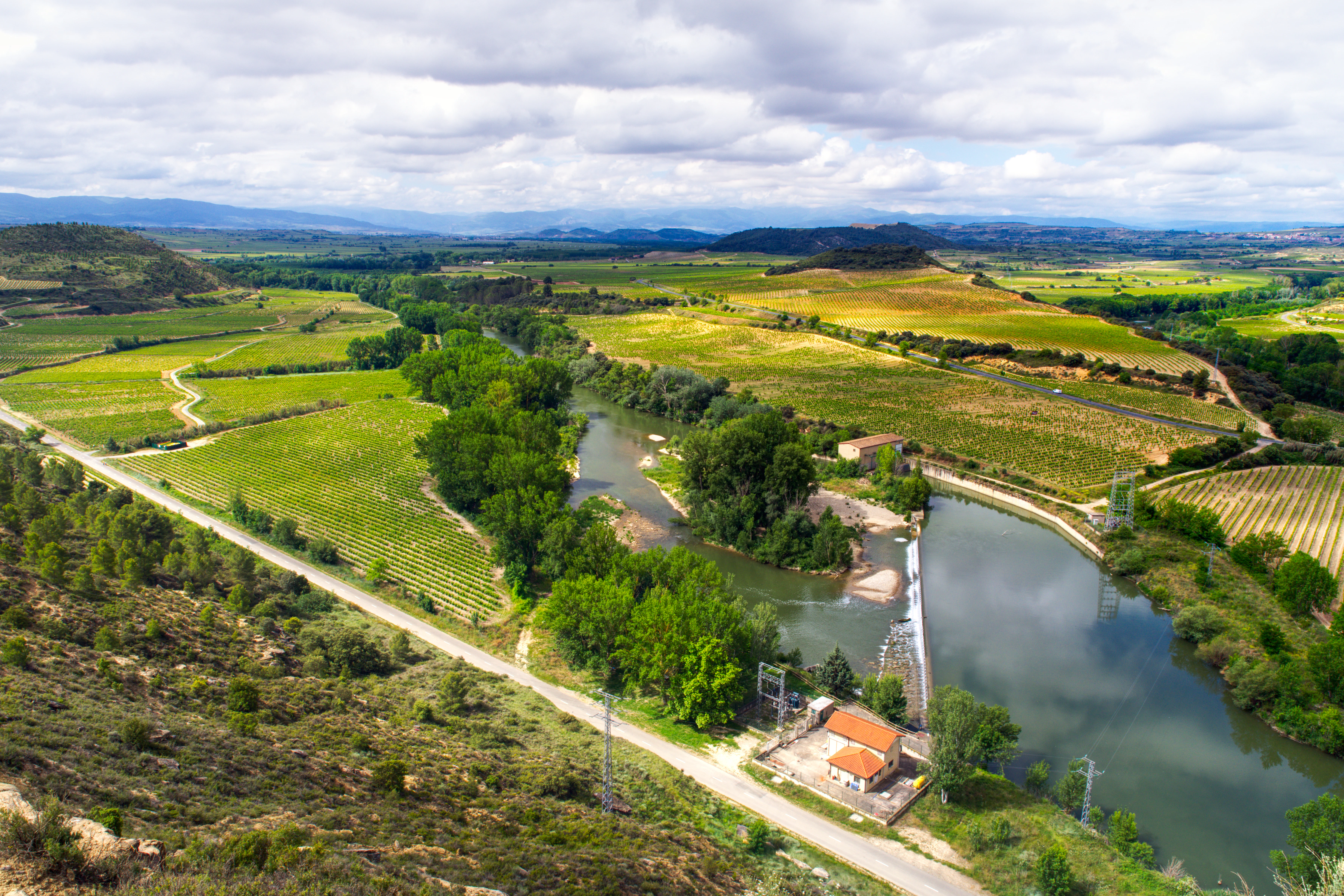 A river running through a lush green countryside