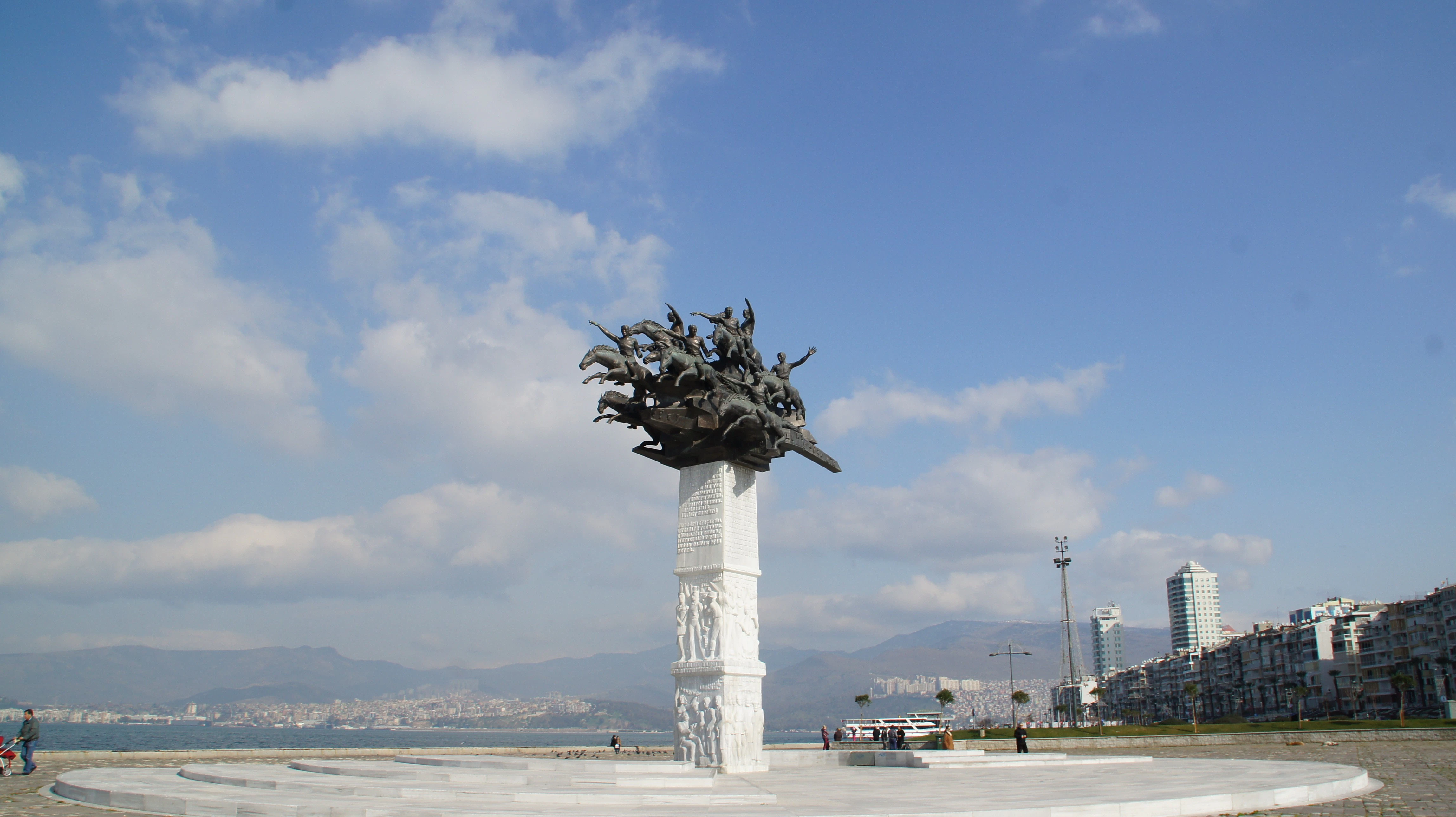 Sculpture on a pedestal by the water