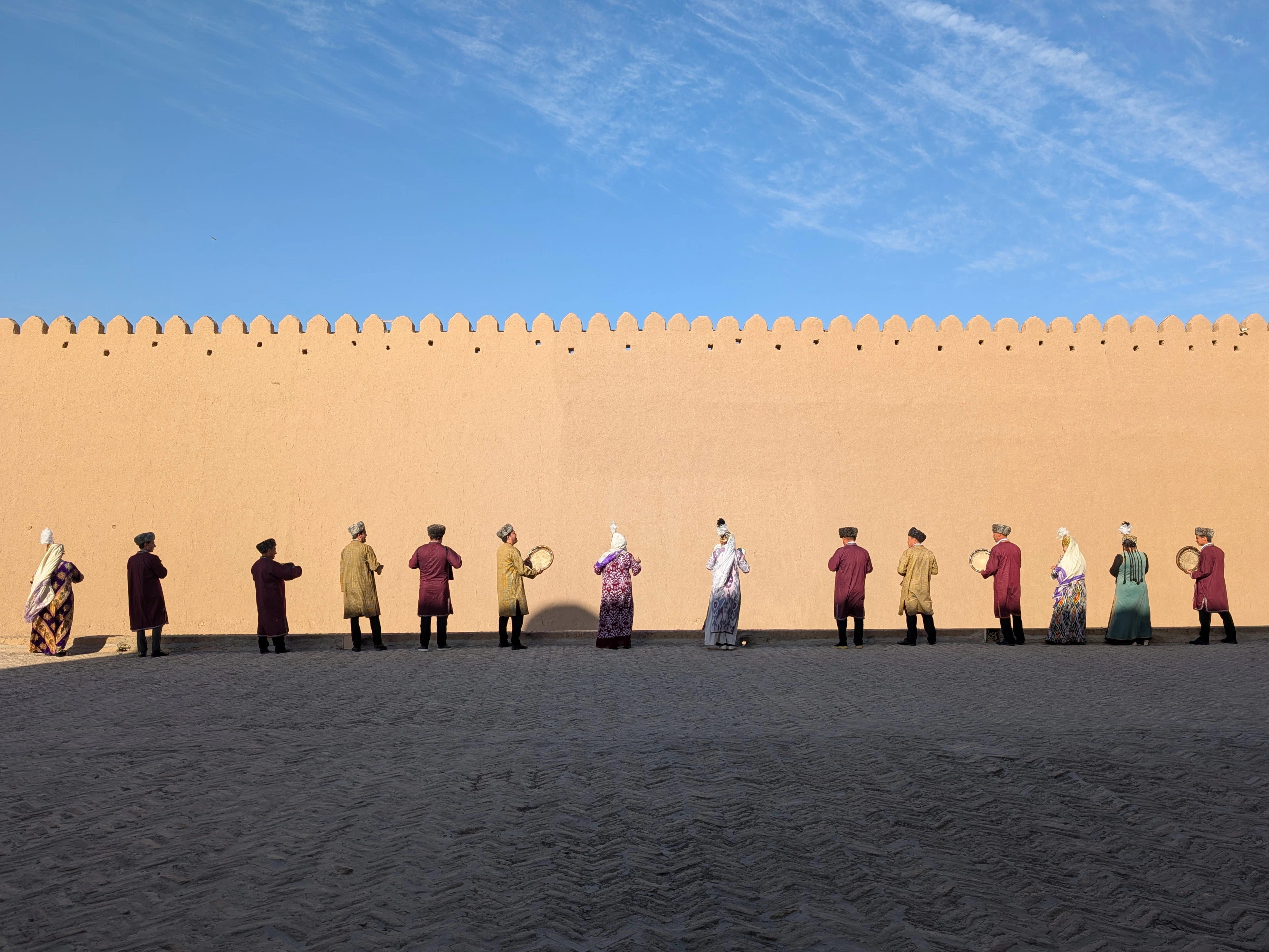 People in traditional clothing stand in a line.