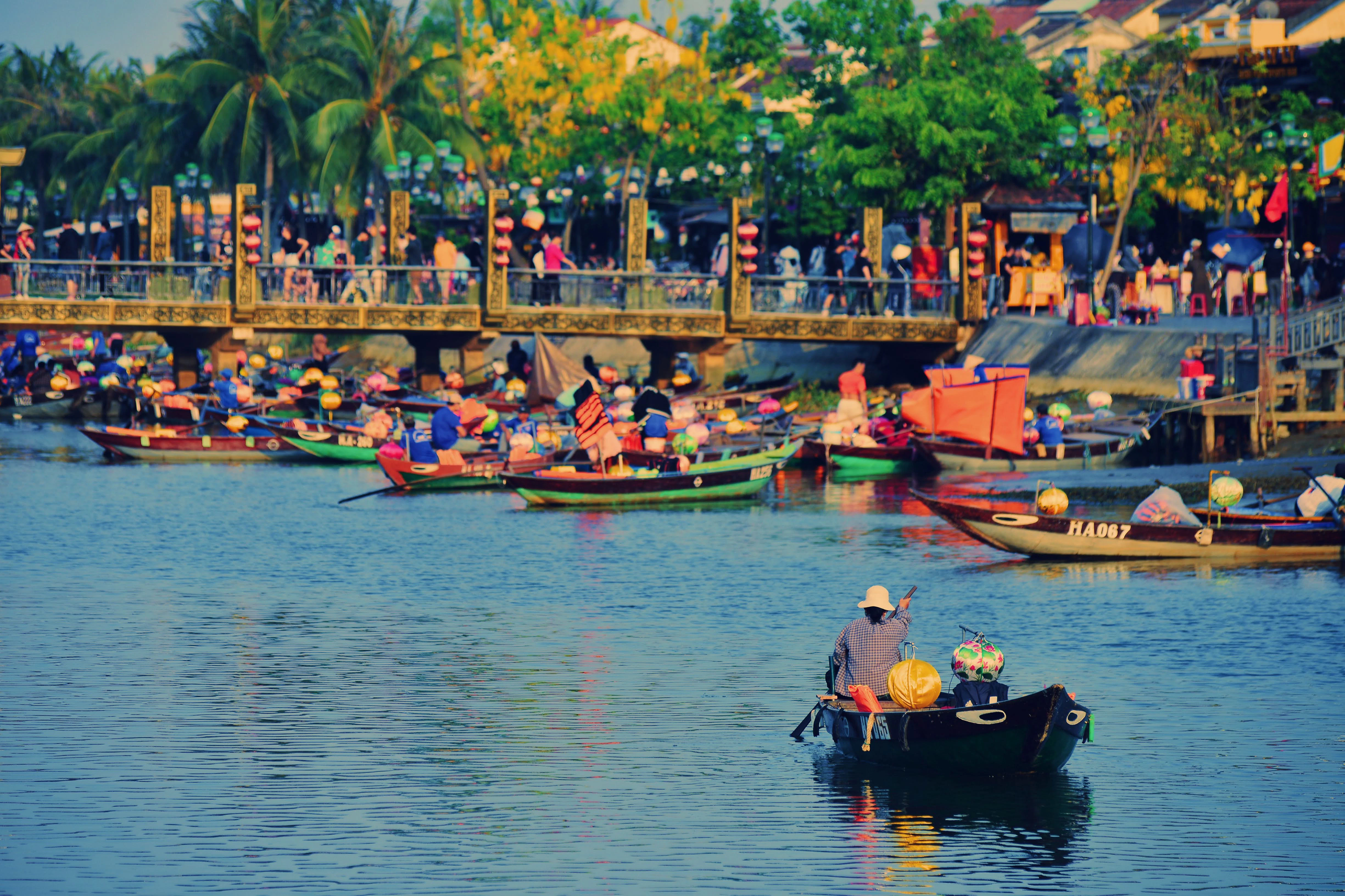 a group of people in small boats on a river