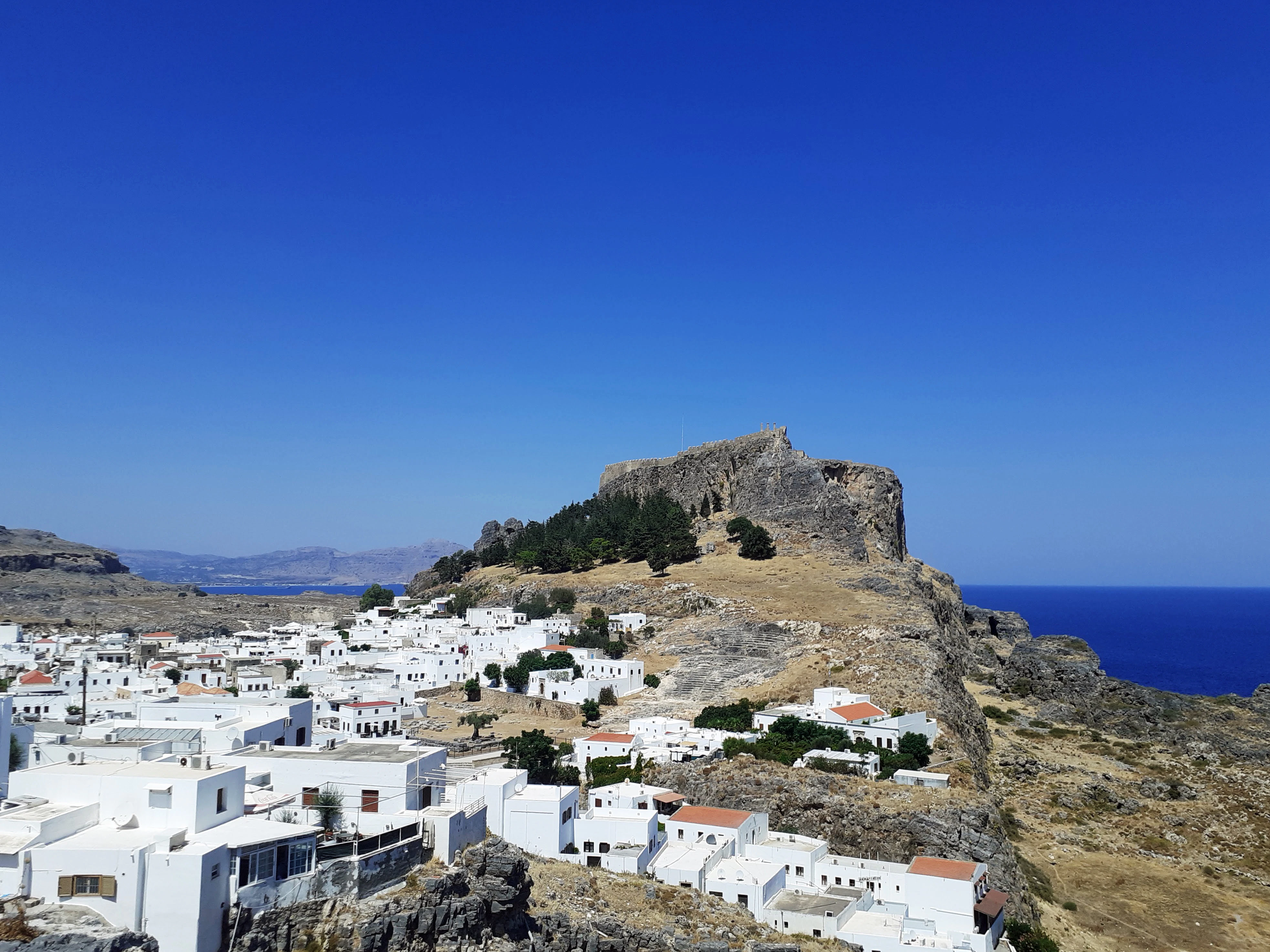 white concrete houses on mountain during daytime
