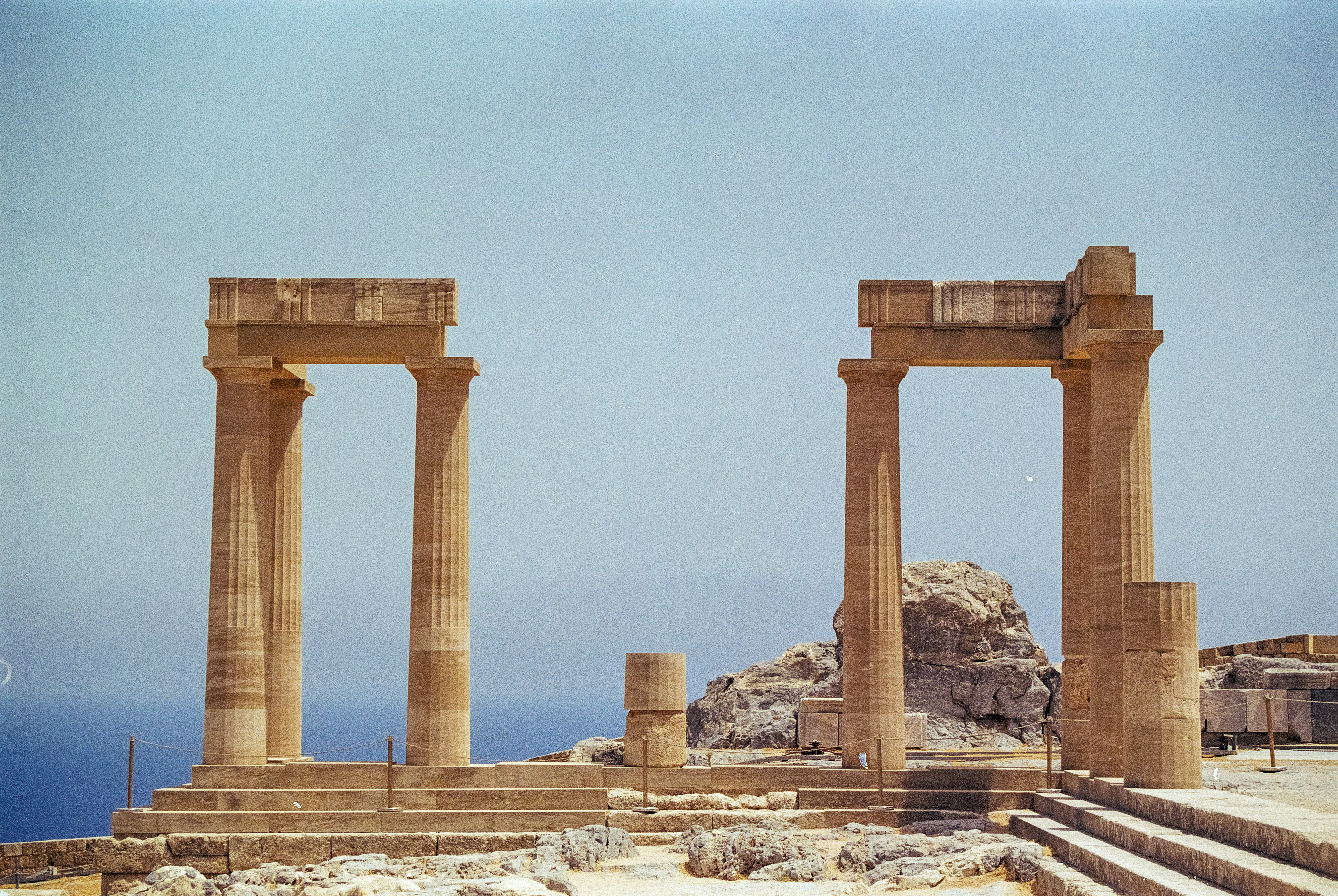 A couple of stone pillars sitting in the middle of a field