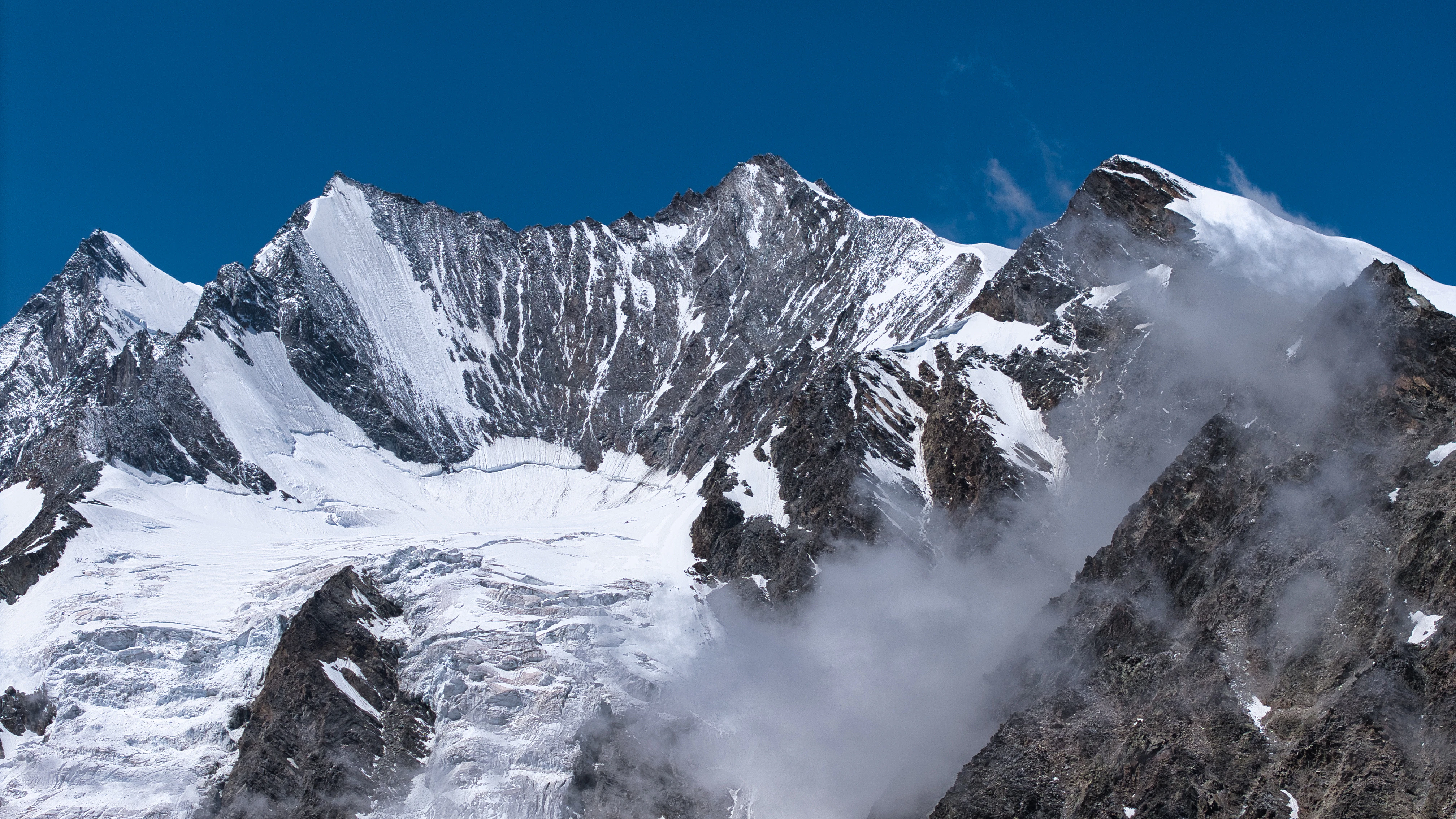 Snow-capped mountains under a clear blue sky