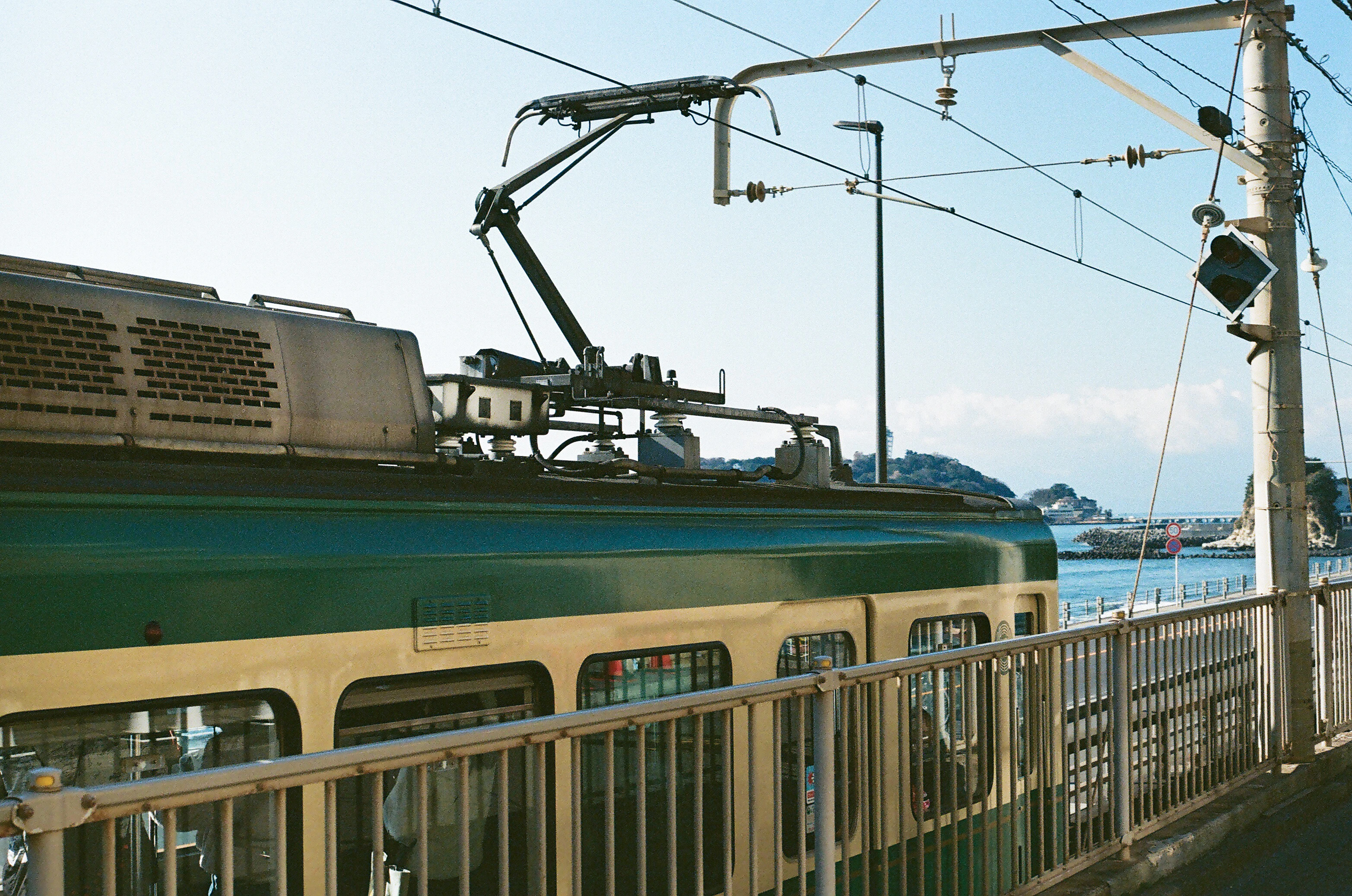 A train traveling down train tracks next to a body of water
