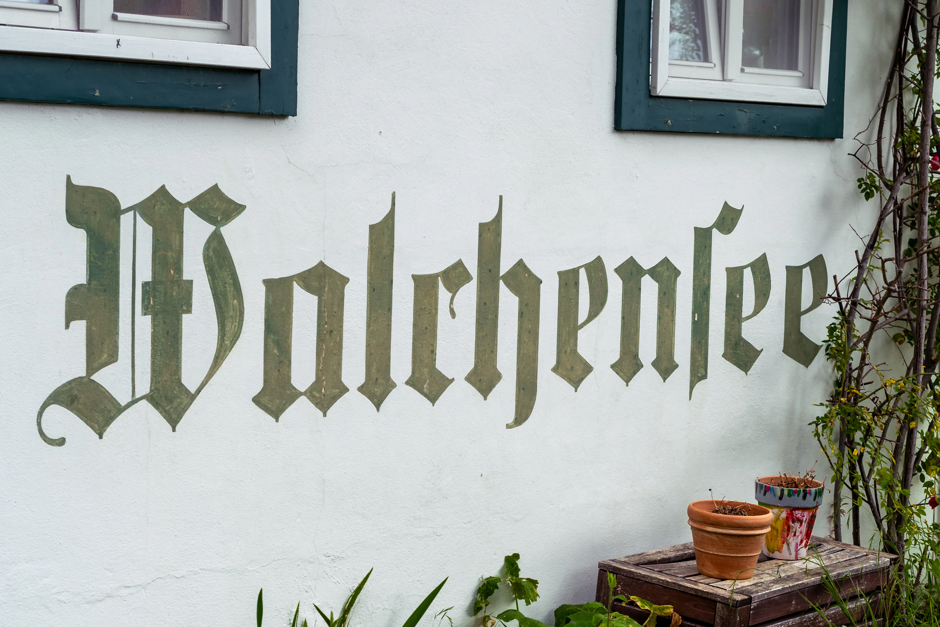 A white building with a sign that says vollbrenlie