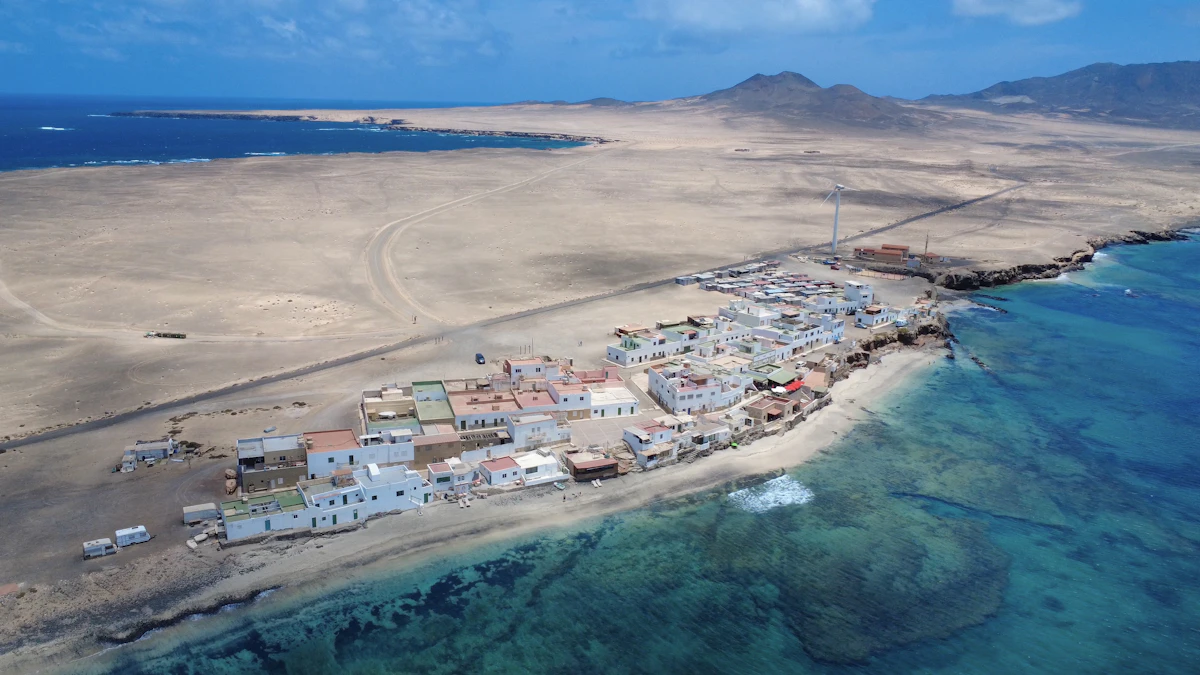 A coastal town sits on a sandy strip.