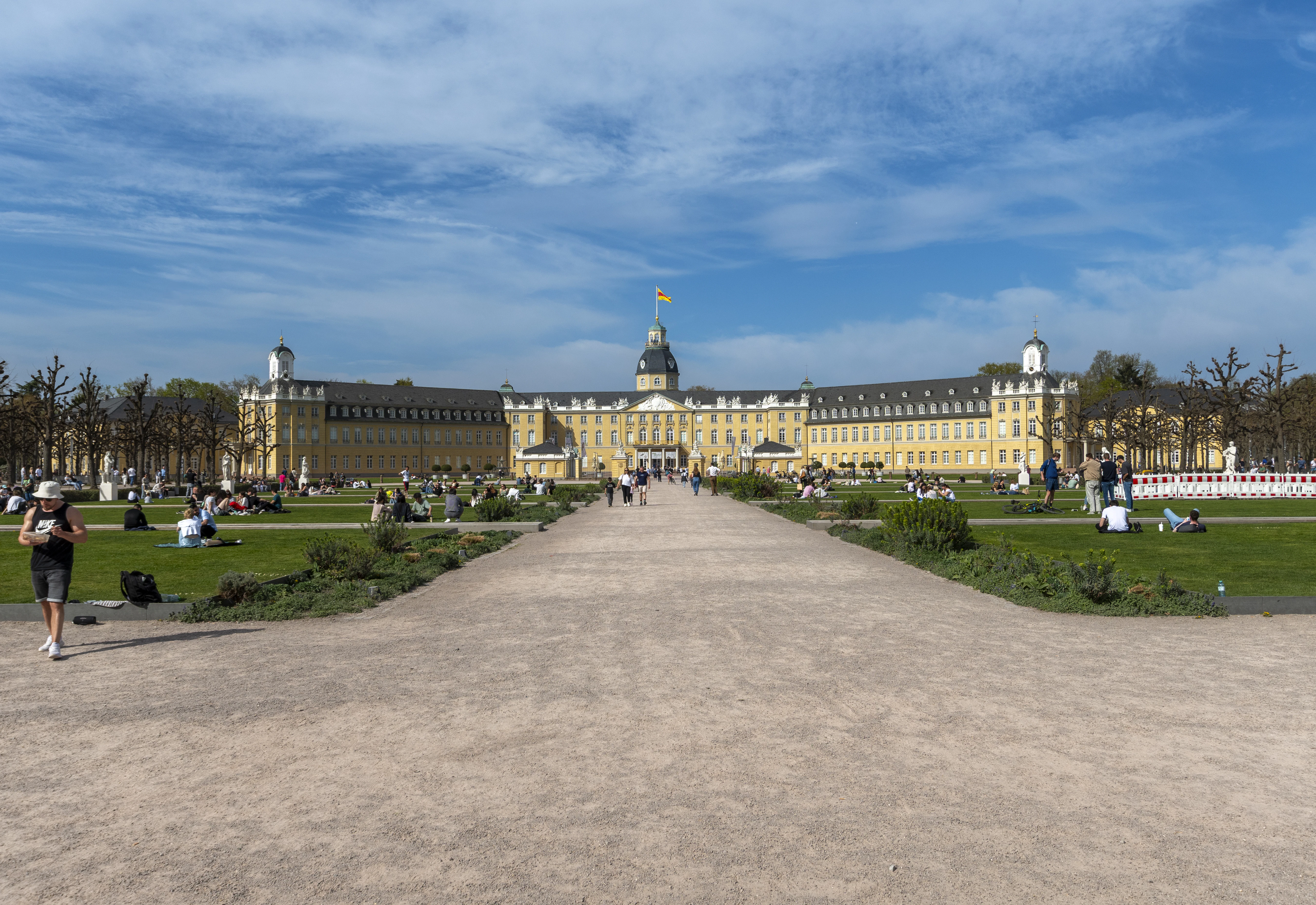 A beautiful palace and green fields under a blue sky.